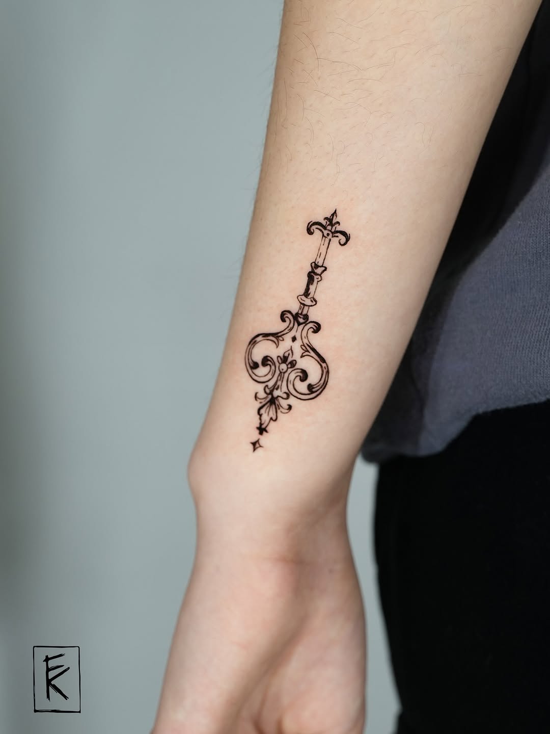 Ornamental key ornamental tattoo on the forearm by elizaveta