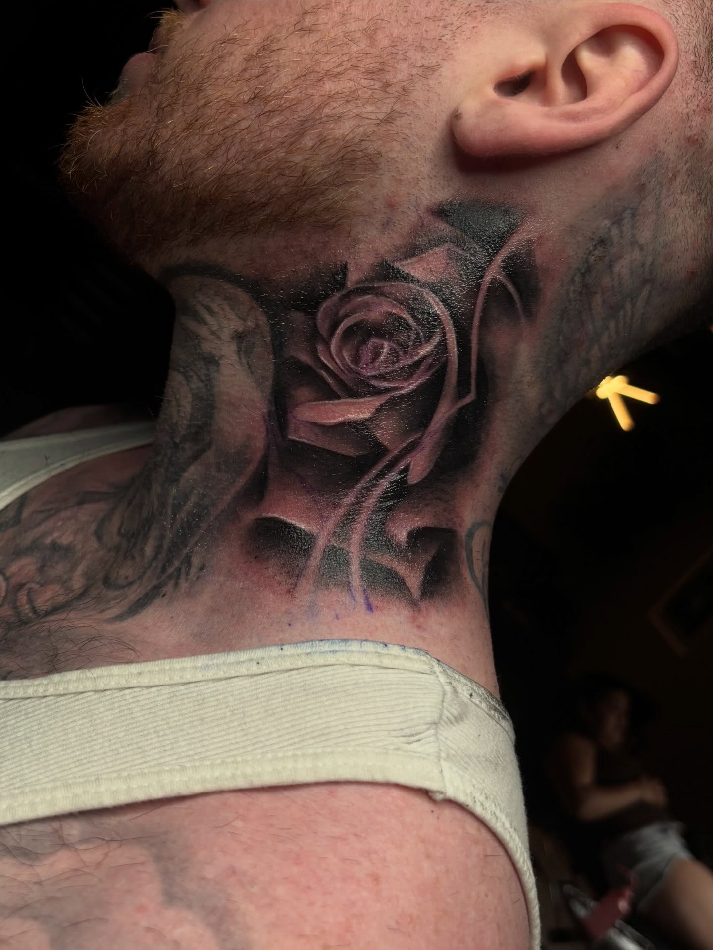 Rose realism tattoo on the neck by Bella Buonopane