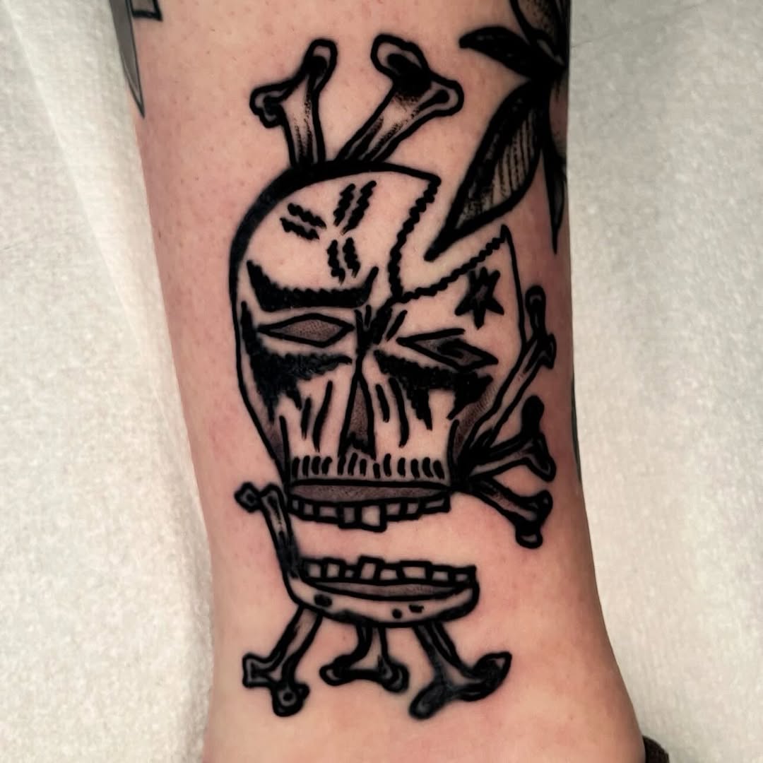 Skull and crossbones American traditional tattoo on the forearm by Devyn Hightower