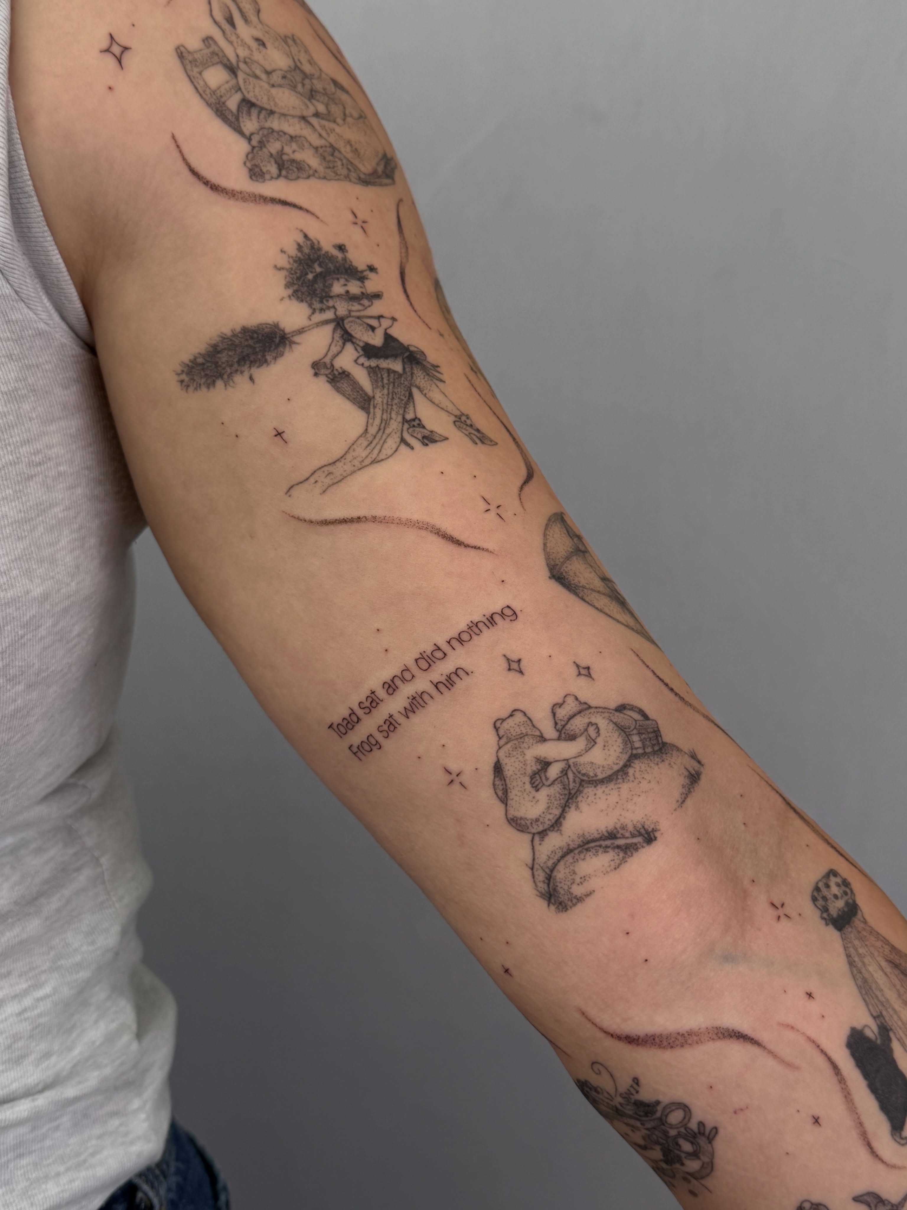 Fairy tale characters black and grey tattoo on the forearm by Henesee Parfitt