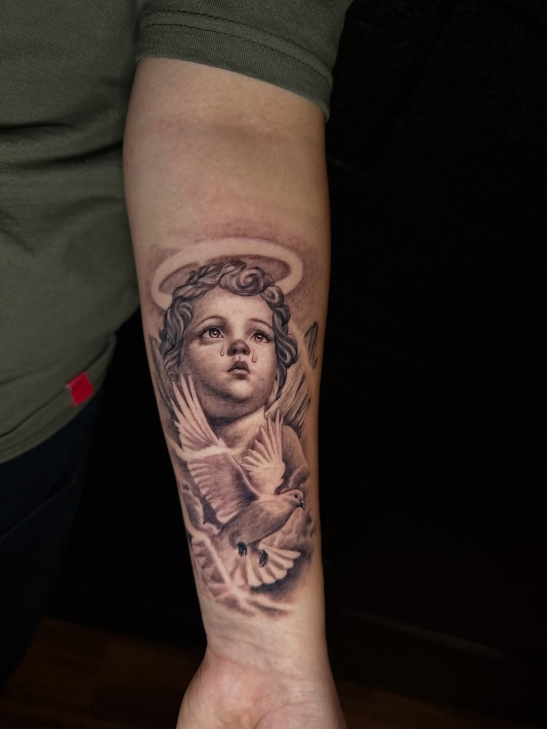 Angel and dove realism tattoo on the forearm by Mario Flores Tattoo