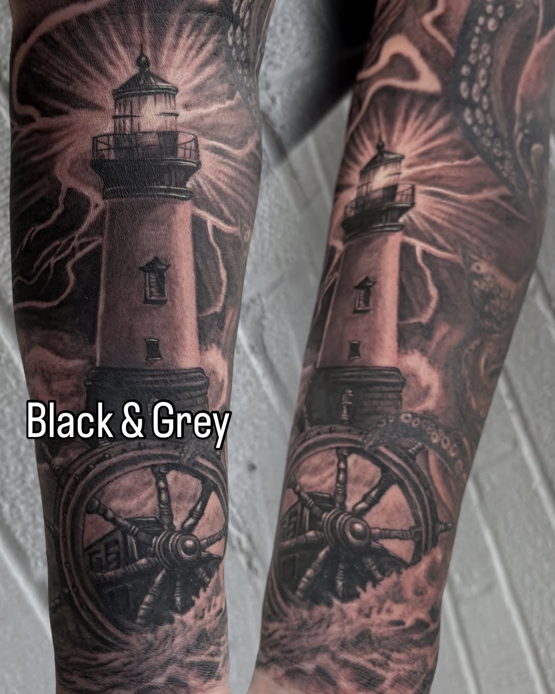 Lighthouse and ship's wheel surrealism tattoo on the forearm by Trusty Dizon Tattoo Artist