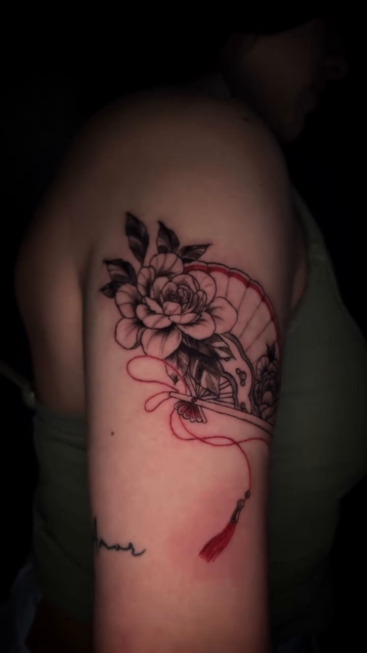 Japanese fan with flowers neo-traditional tattoo on the upper arm by bev