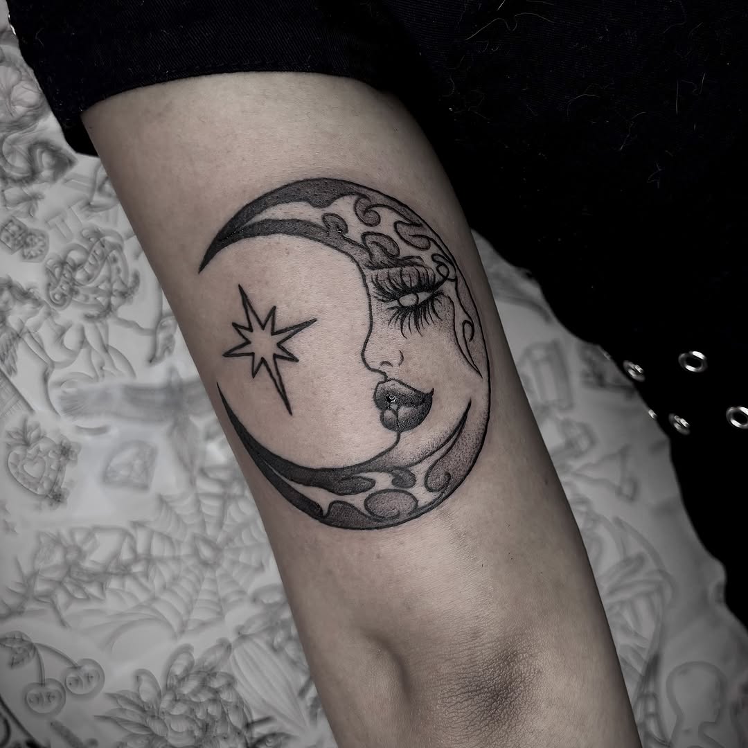 Crescent moon with face and star realism tattoo on the forearm by Weho Tattoo Artist Lupe