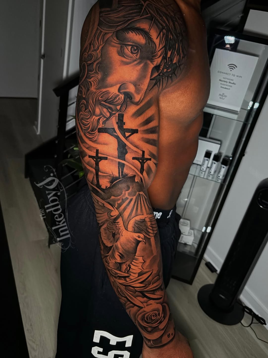 Jesus Christ with crosses and dove Chicano tattoo on the forearm by Jaylen - Atlanta Tattoo Artist