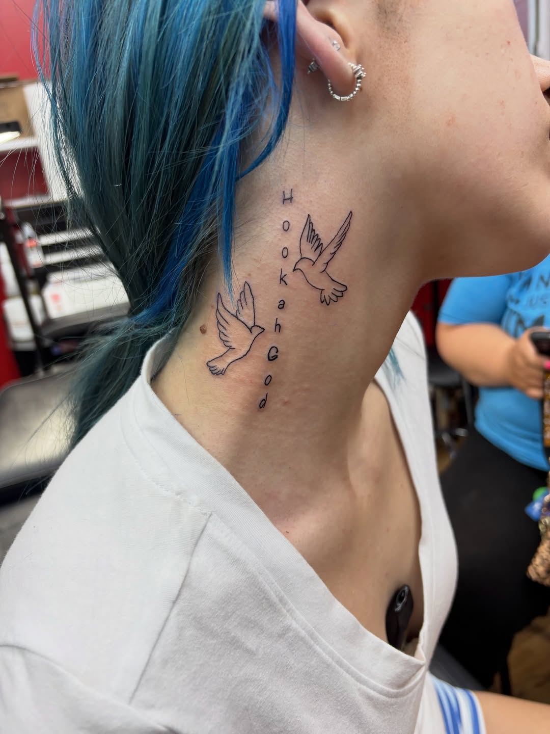 Two doves and lettering fine line tattoo on the neck by Art Plug