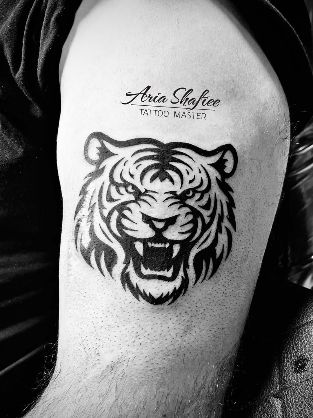 Tiger head tribal tattoo on the thigh by Aria Shafiee
