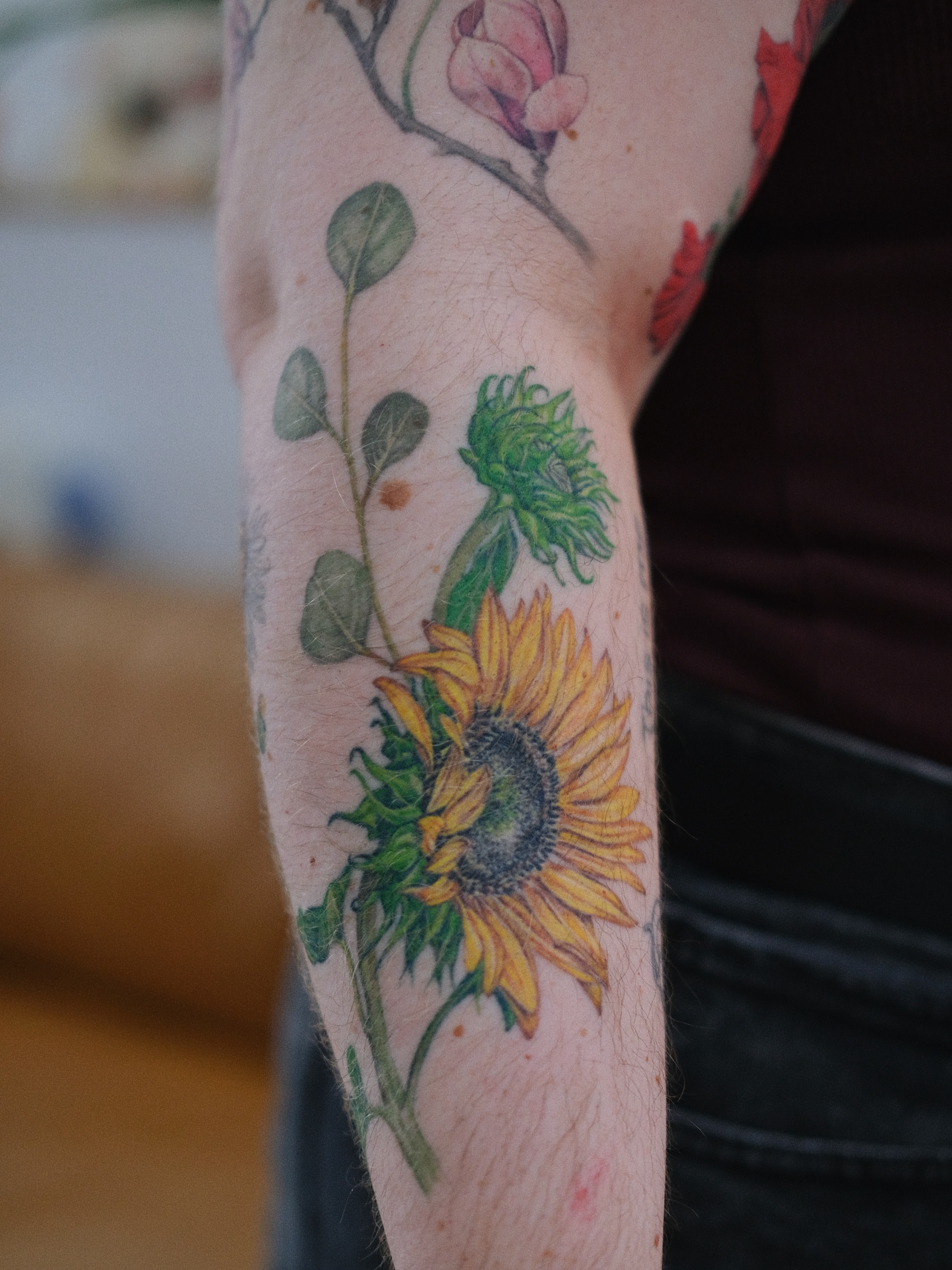 Sunflower realism tattoo on the forearm by Jiemin Lin