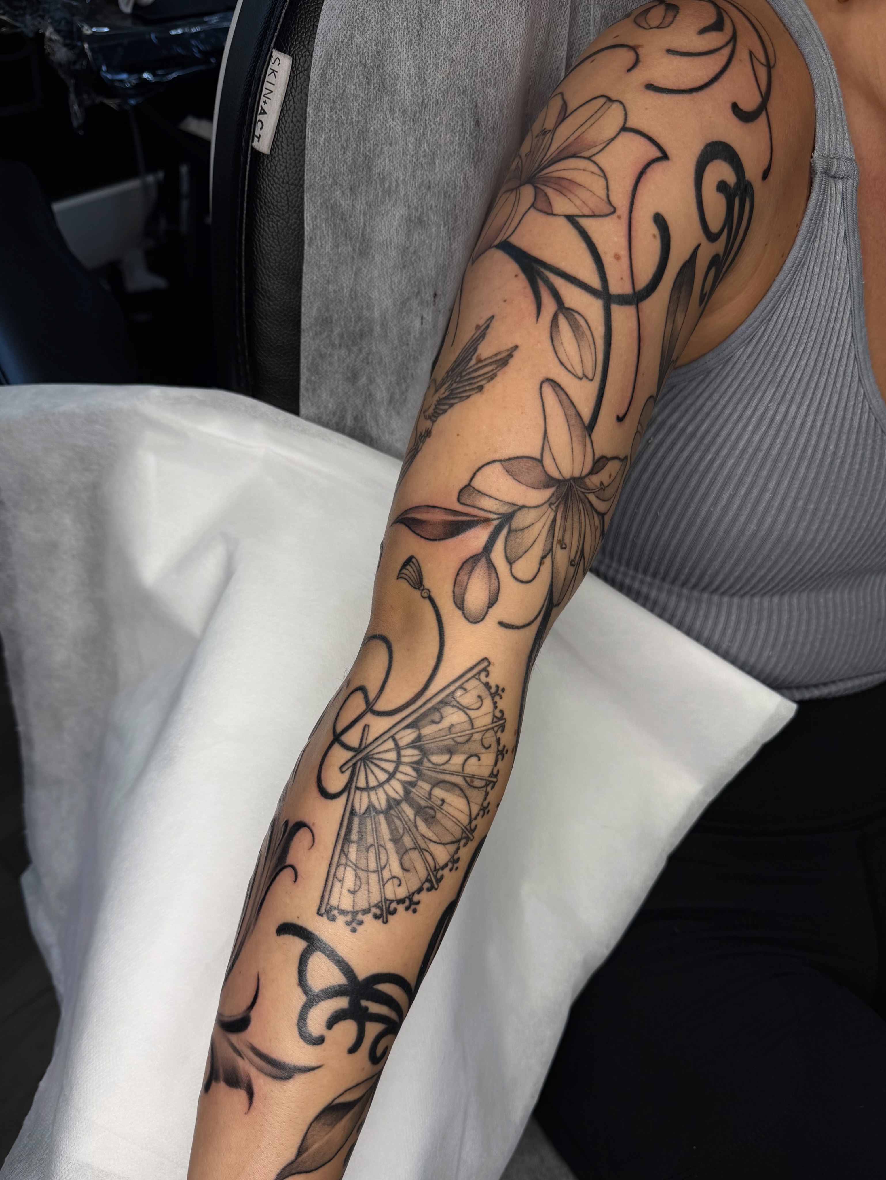 Floral and abstract ornamental tattoo on the forearm by Red