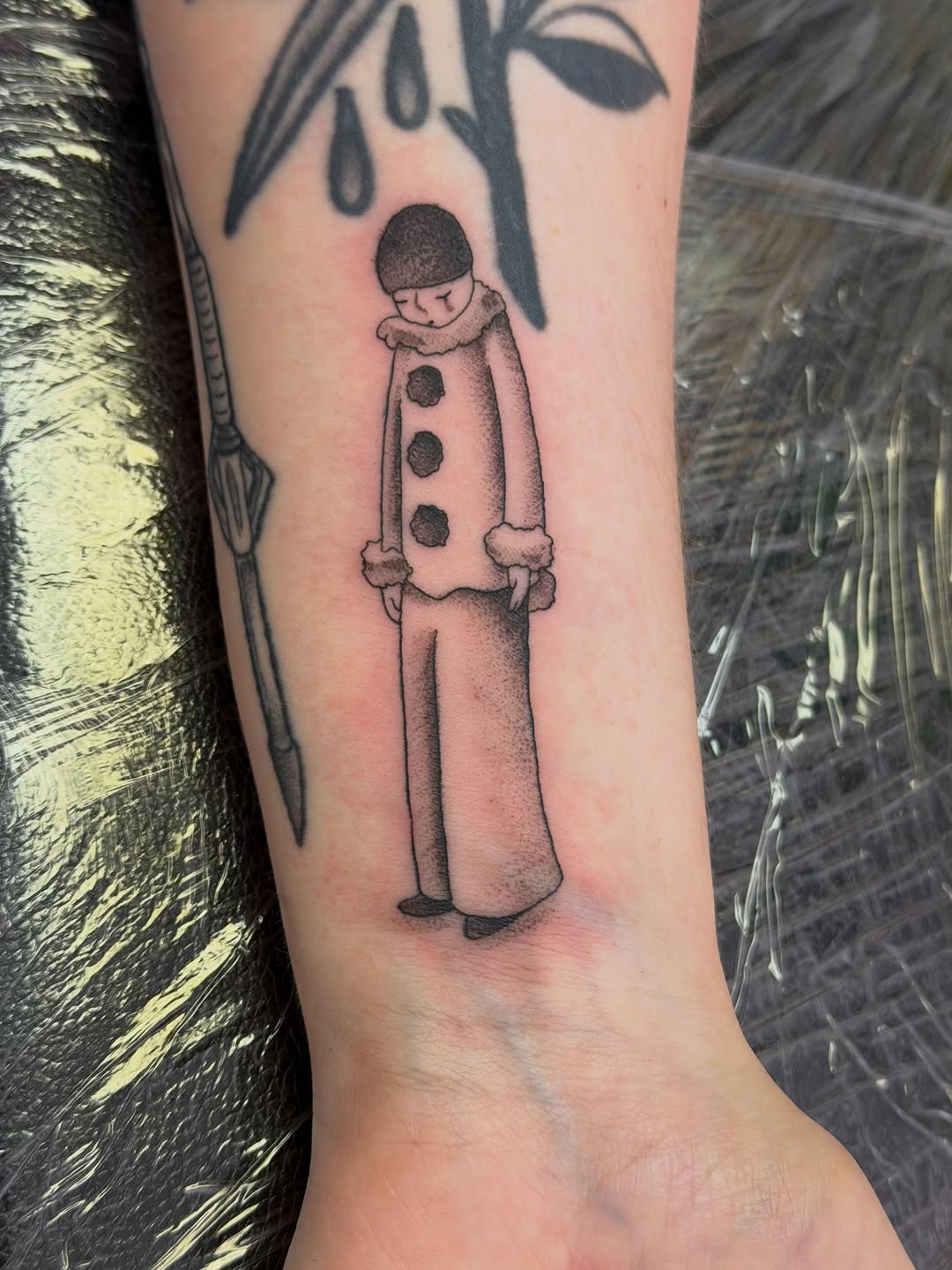 Sad clown ignorant tattoo on the forearm by Stvn Geyer, Urbandale, Iowa