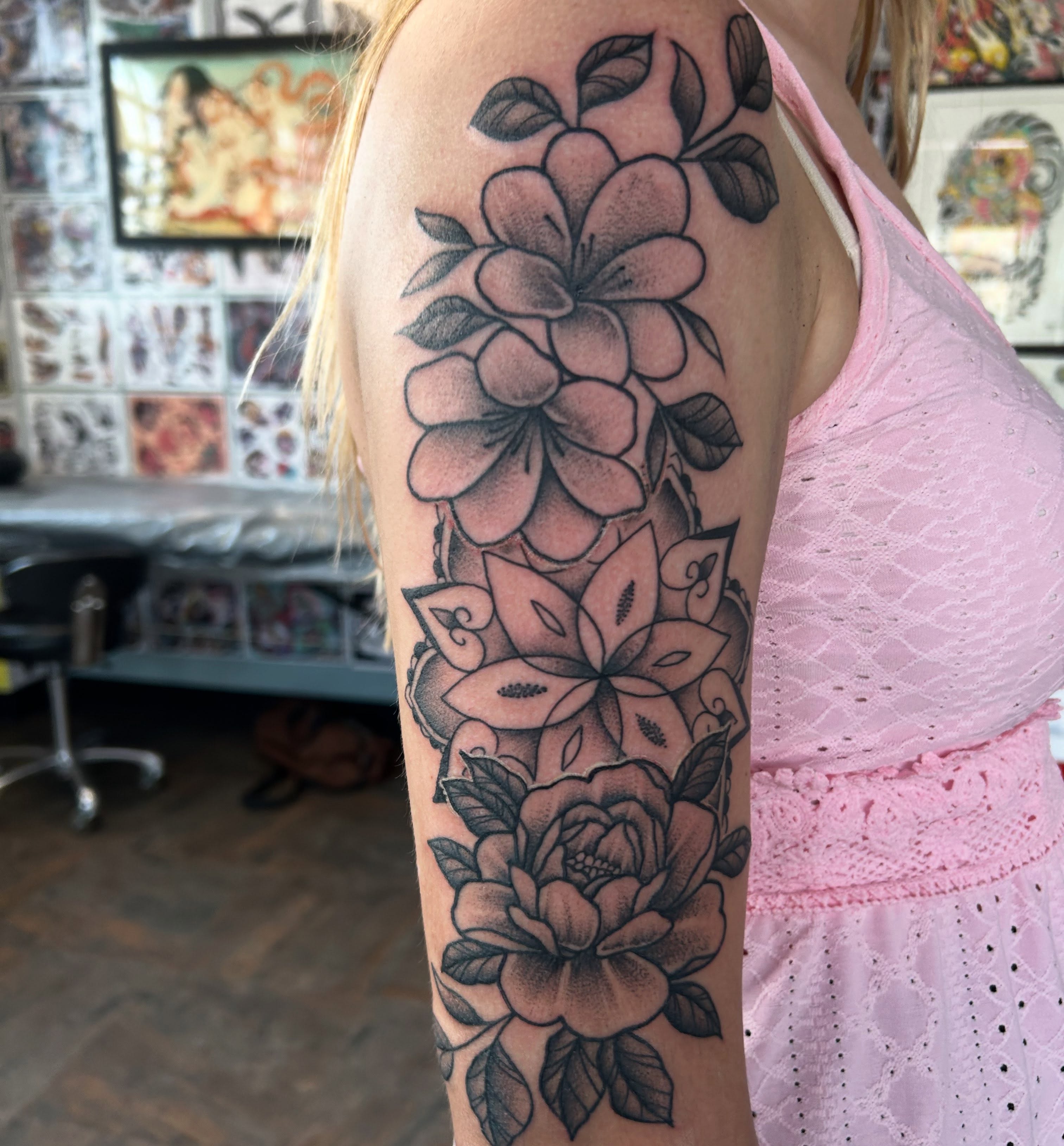 Floral bouquet black and grey tattoo on the forearm by Randy Bray