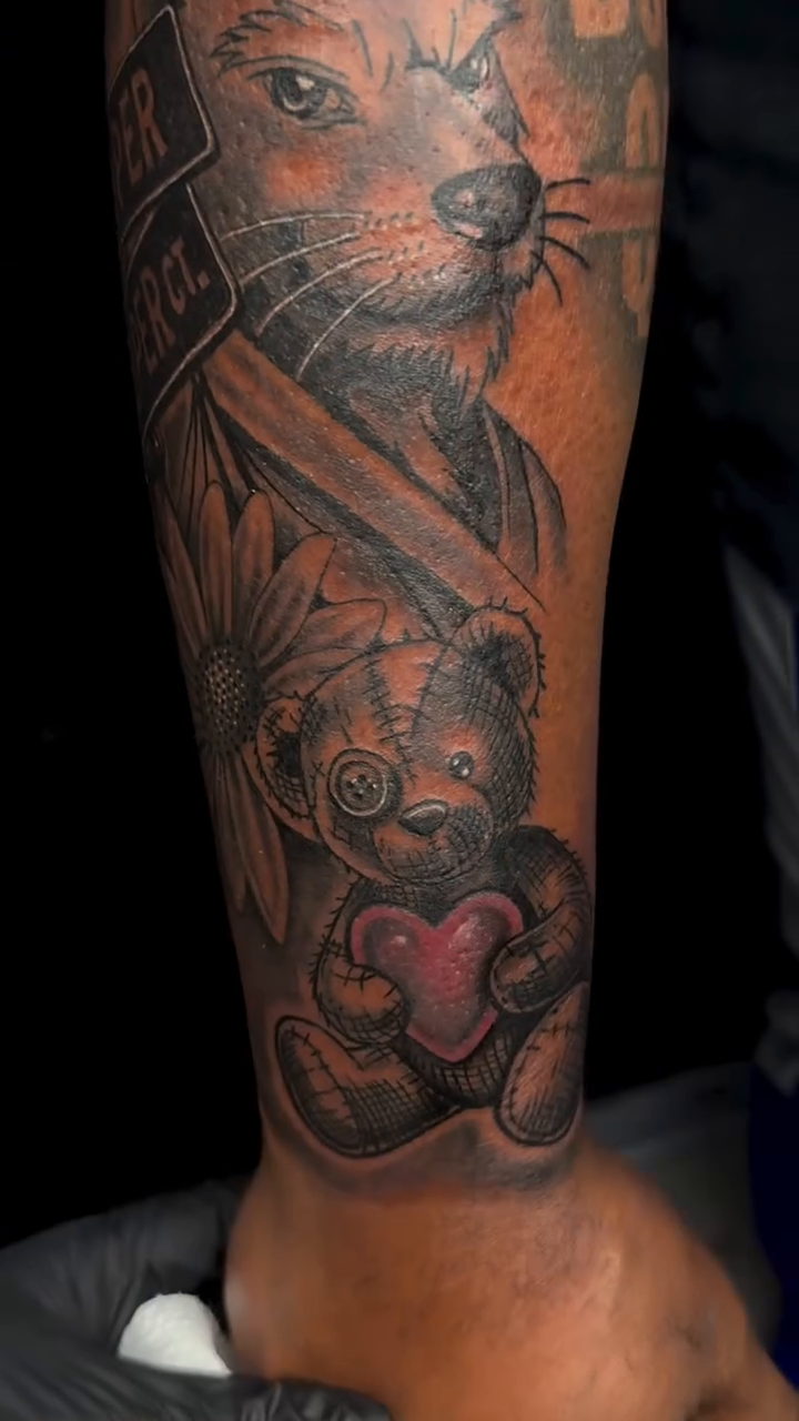 Wolf with teddy bear and flowers Chicano tattoo on the forearm by Left My Mark
