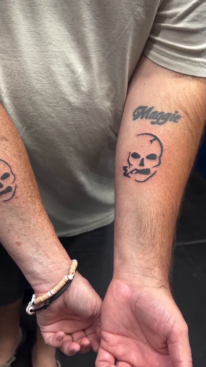 Skull with name minimalist tattoo on the forearm by Tattoo Takayo