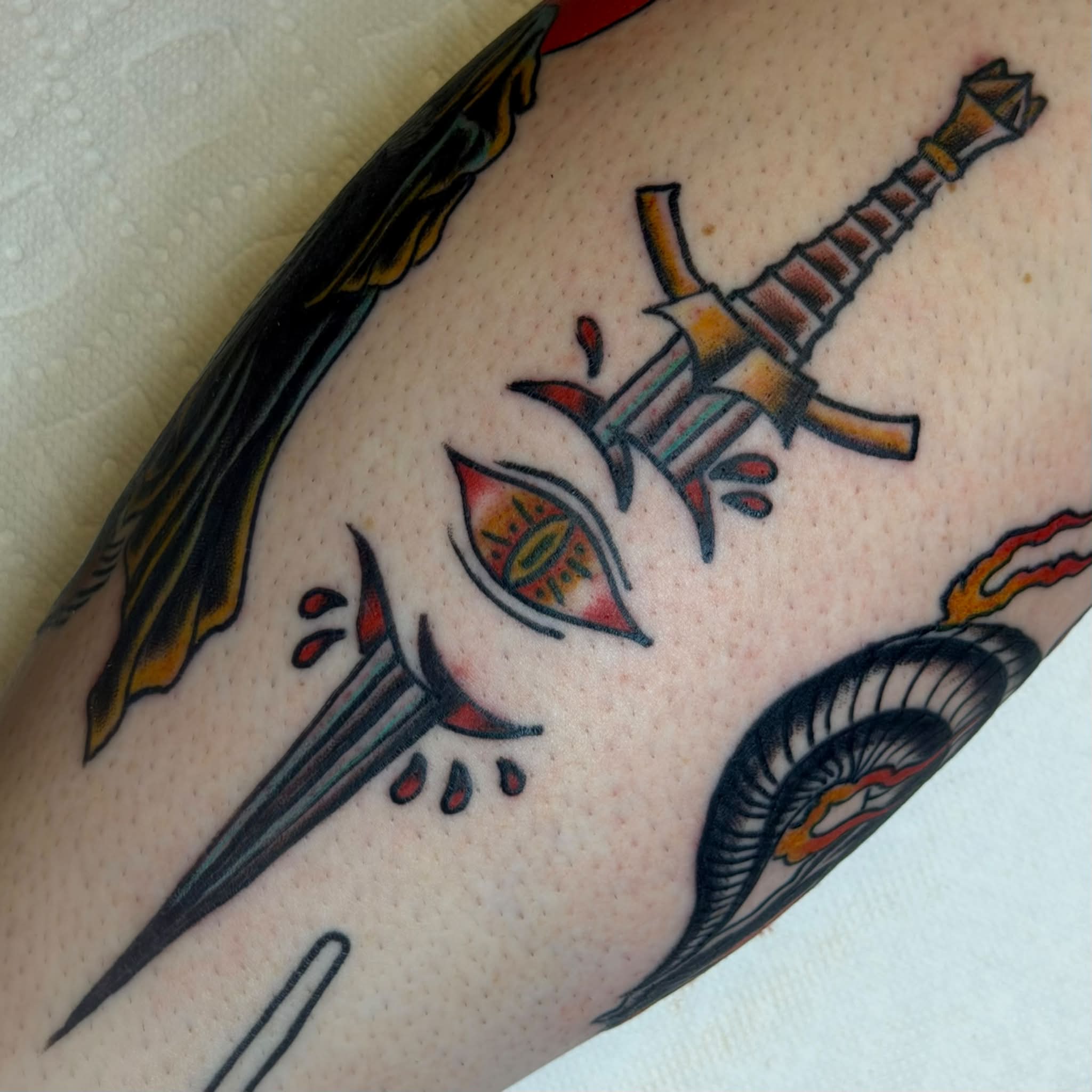 Sword and eye American traditional tattoo on the forearm by Kenneth Prince