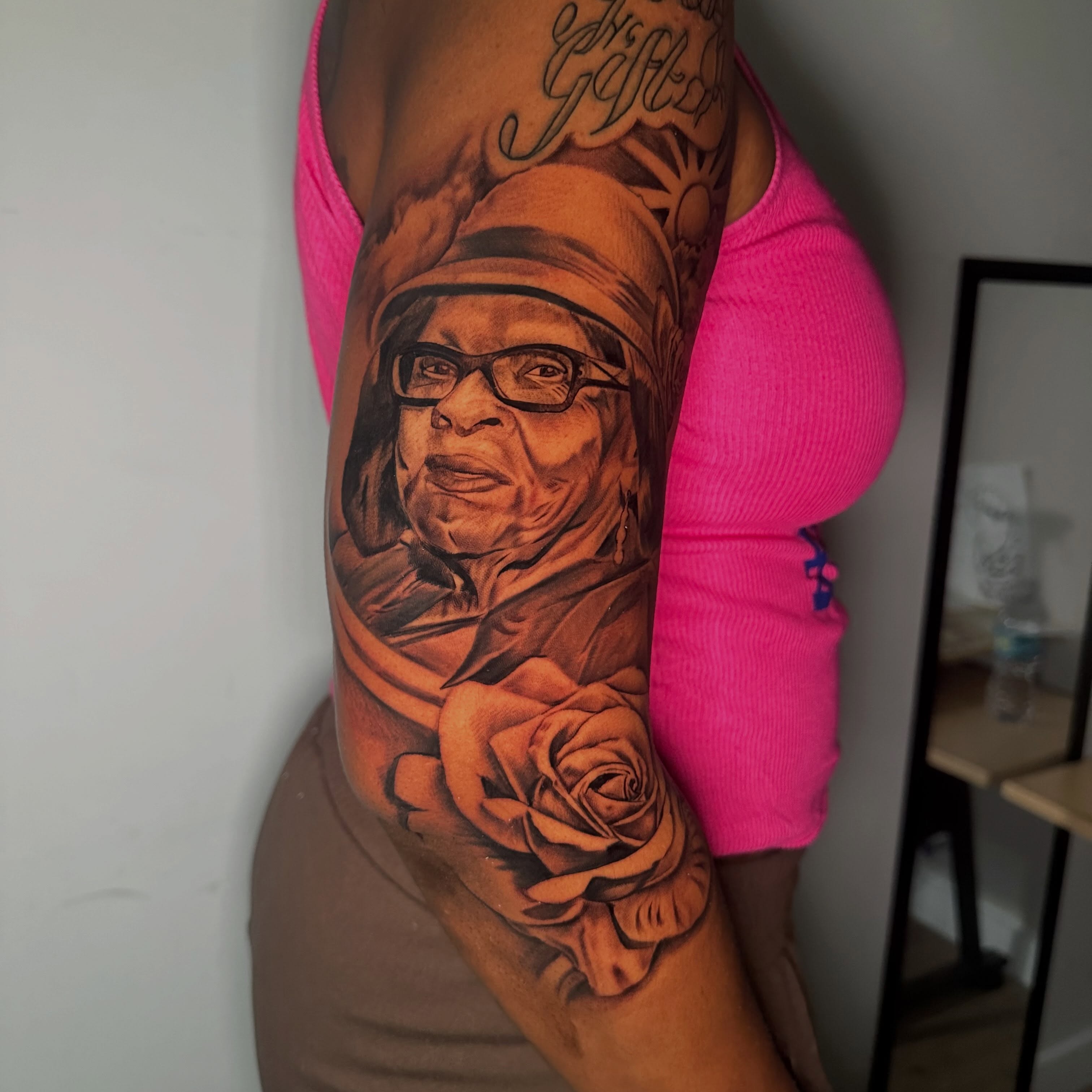 Portrait of woman with rose realism tattoo on the forearm by I Am Mawlo! Welcome Fellow Mawlonians