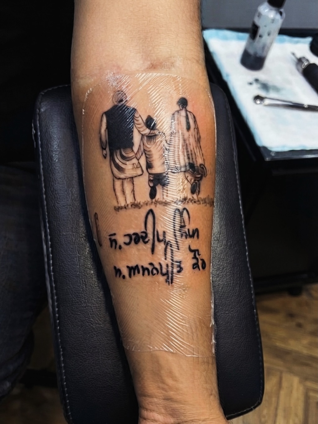 Family walking with script tattoo on the forearm by I N K S L A y e R