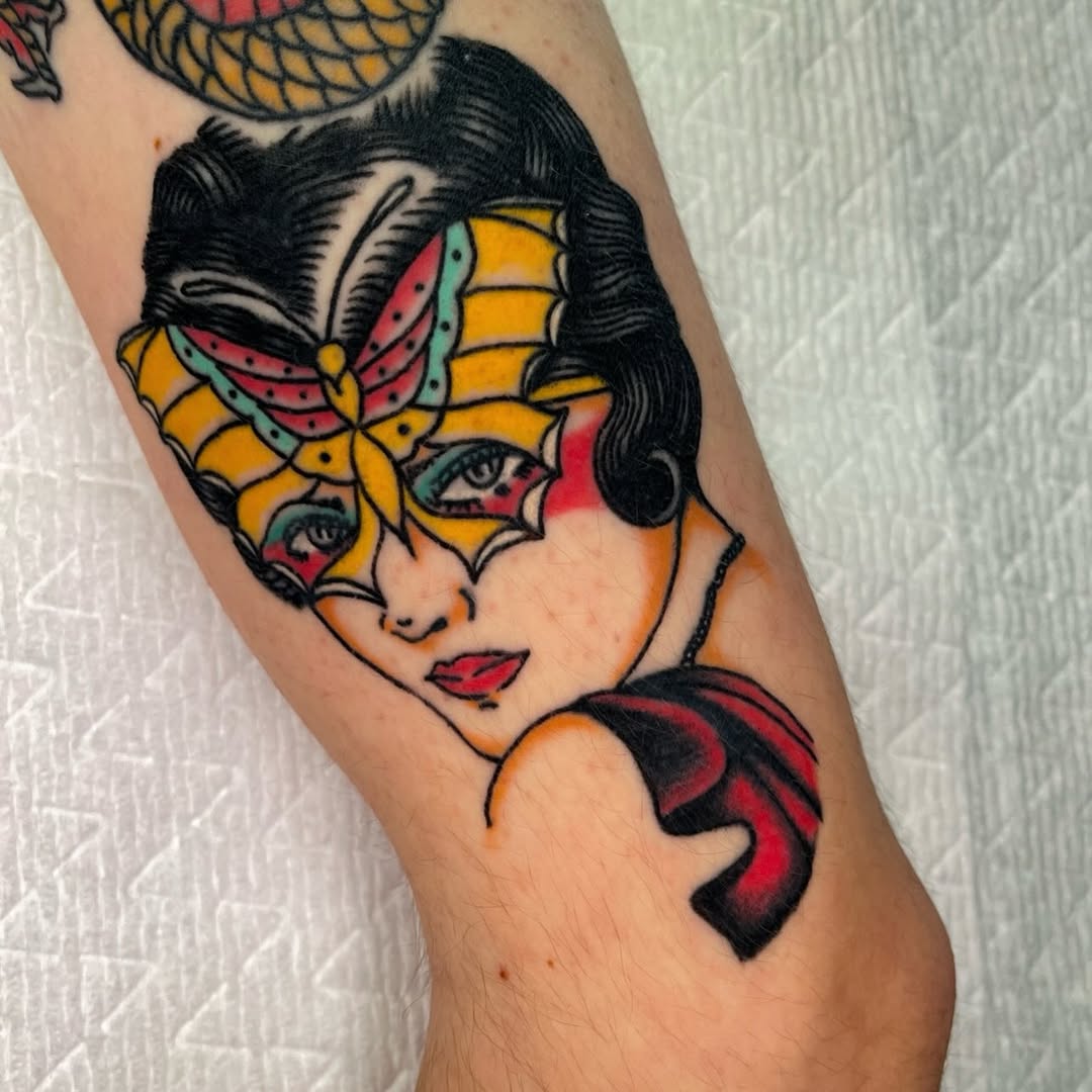 Woman with butterfly mask neo-traditional tattoo on the forearm by Devyn Hightower