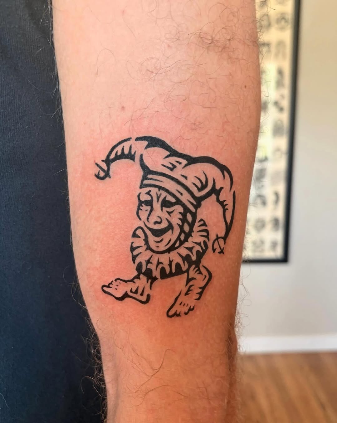 Jester realism tattoo on the forearm by M