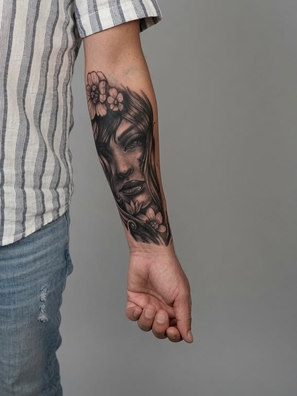 Woman's face realism tattoo on the forearm by Dmitrii Damoer, New York, New York