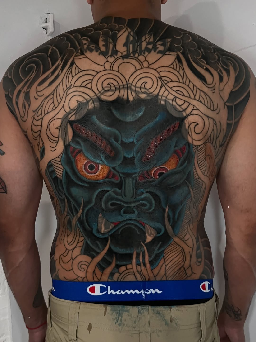 Oni mask and clouds tattoo on the back by Eoghann McGregor
