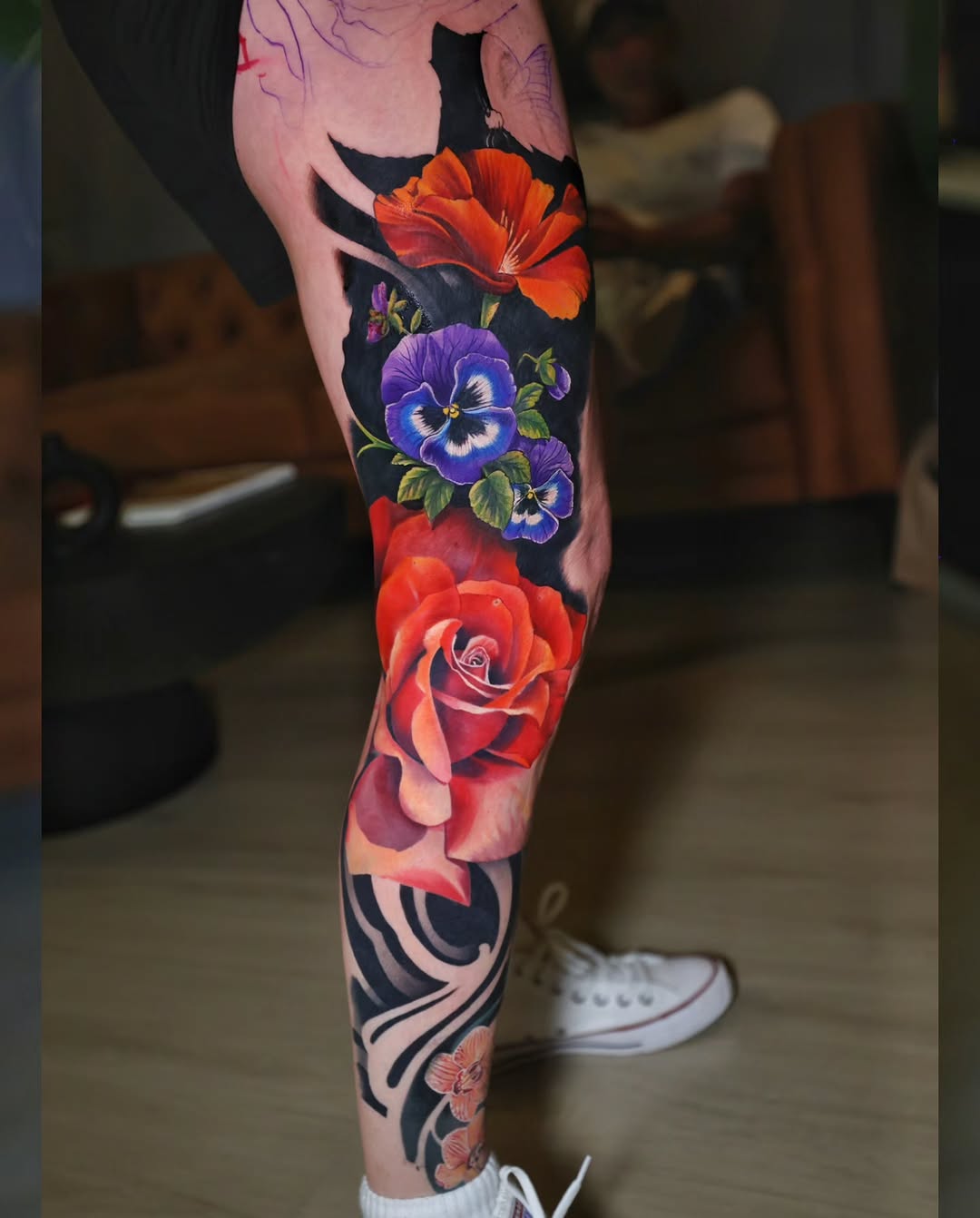 Rose and pansies neo-traditional tattoo on the leg by Marek Pawlik