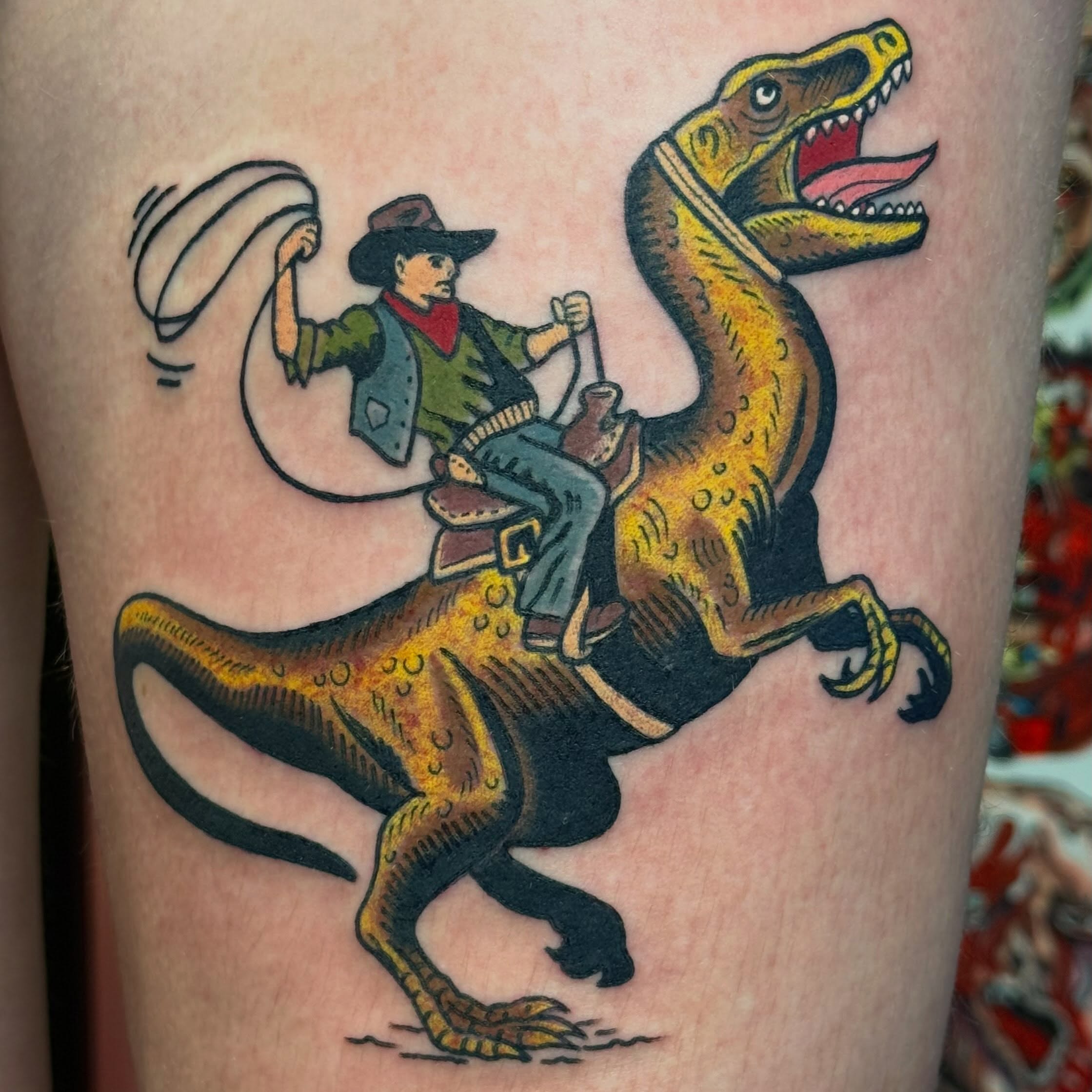 Cowboy riding dinosaur American traditional tattoo on the thigh by Timothy Kenee