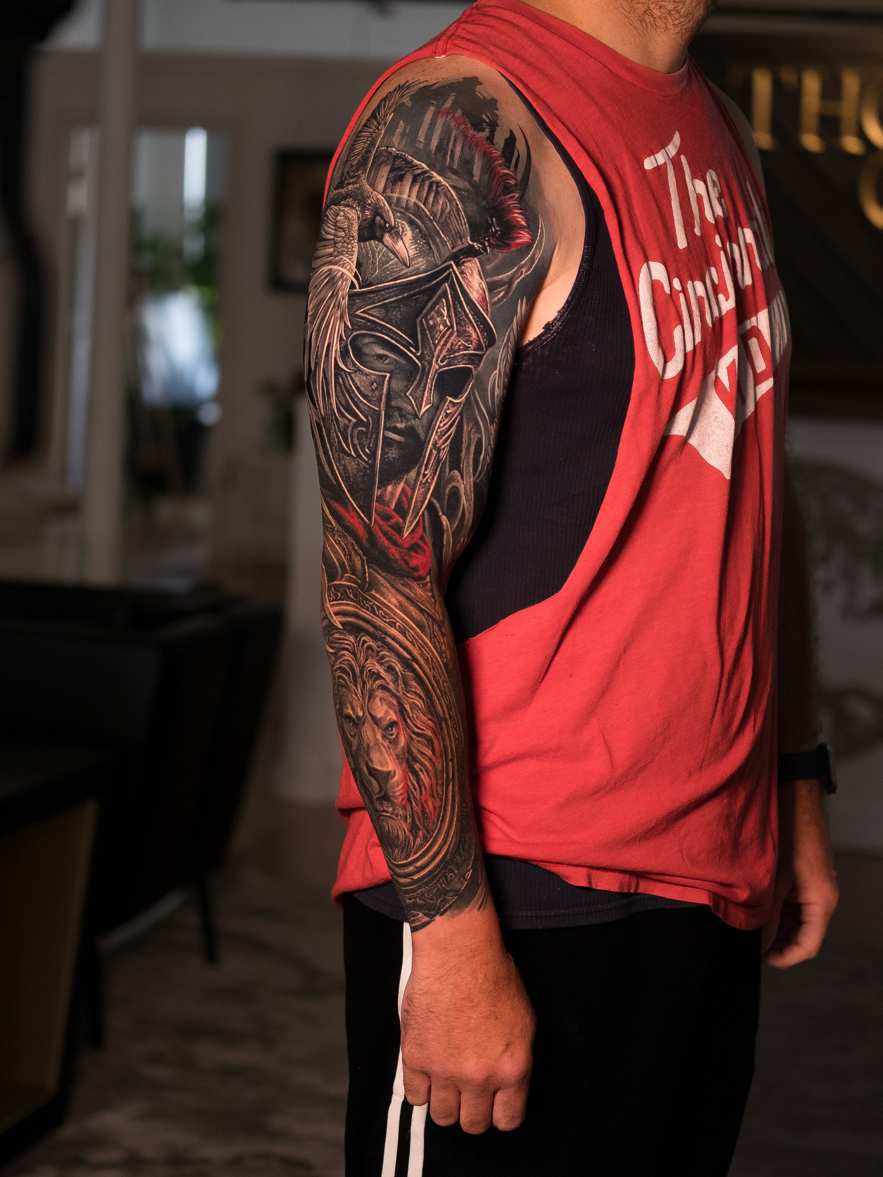 Spartan helmet and lion Japanese tattoo on the upper arm by Christopher Powell