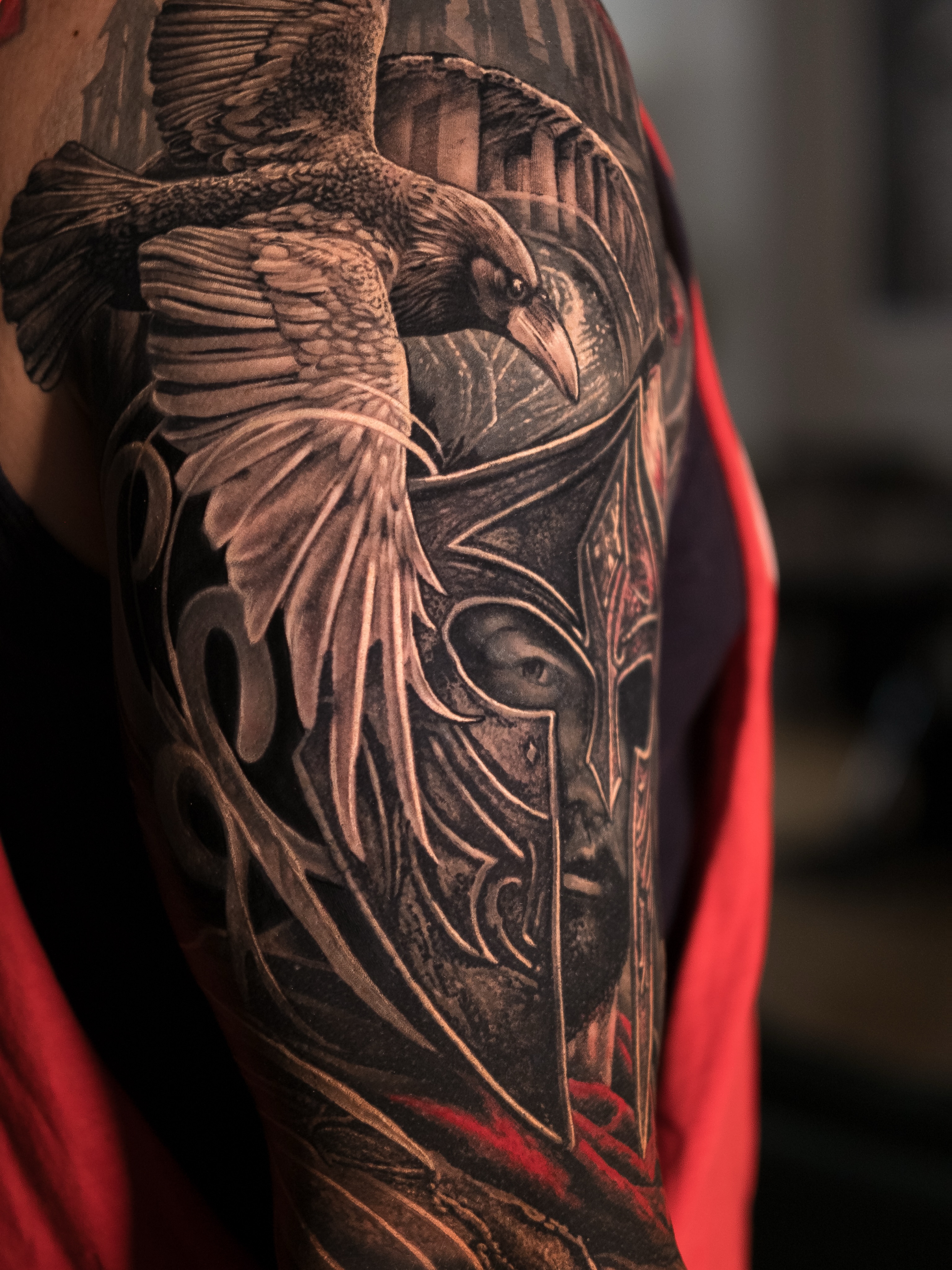 Raven and warrior helmet realism tattoo on the forearm by Christopher Powell