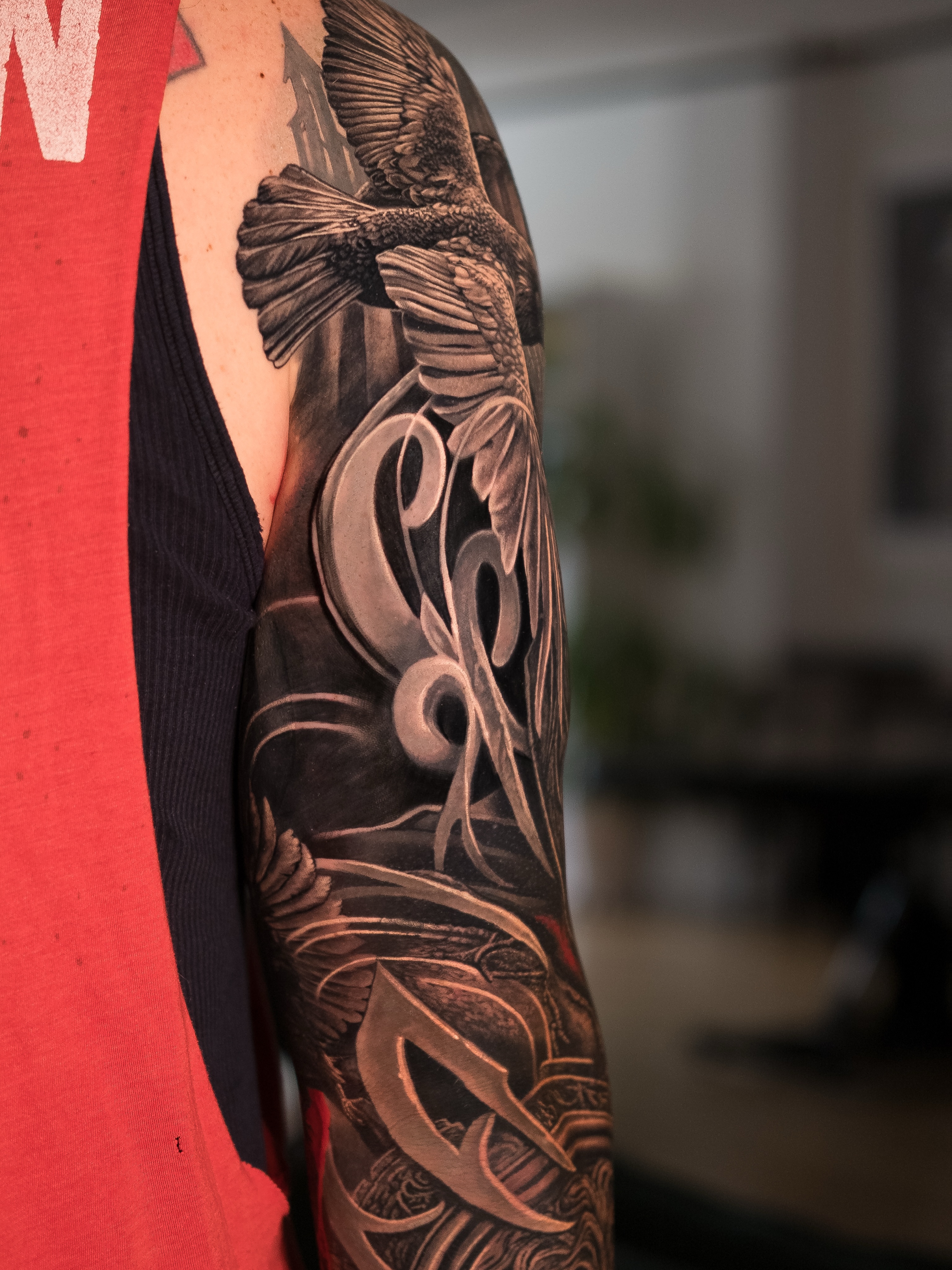 Eagle and ornamental lettering Japanese tattoo on the upper arm by Christopher Powell