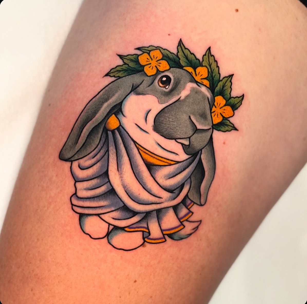 Rabbit wearing a dress American traditional tattoo on the thigh by Chelstine, Encinitas, California