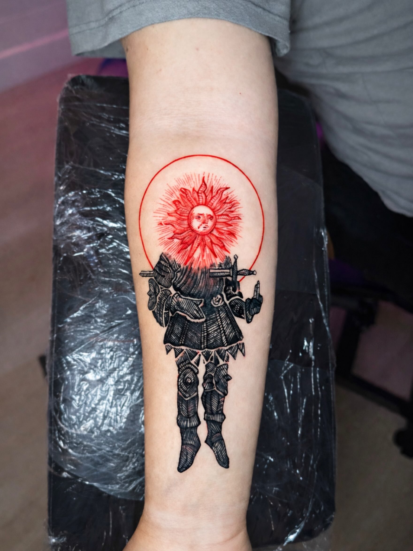 Warrior with sun black and grey tattoo on the forearm by Kelsoink