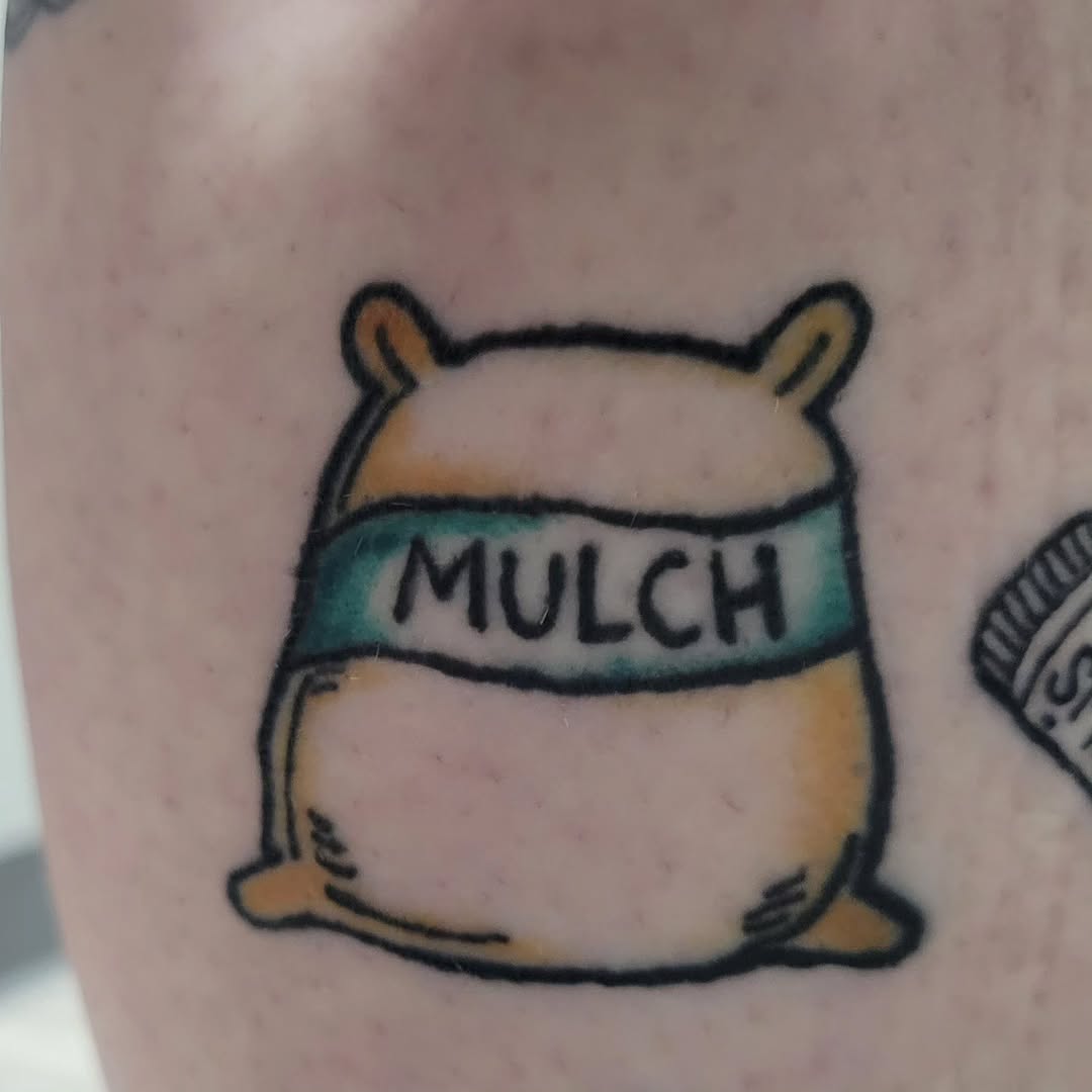 Bag of mulch tattoo on the forearm by Peach & Poke, Lethbridge, Alberta