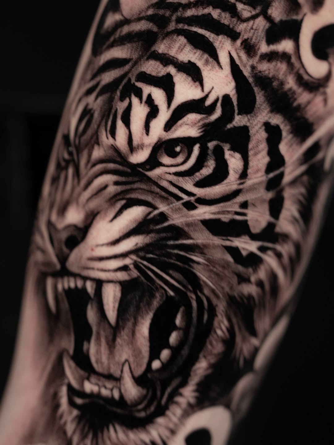 Roaring tiger face realism tattoo on the forearm by Idalia Pulido