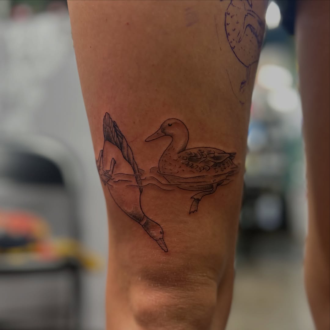 Ducks swimming and diving fine line tattoo on the forearm by Natalie Johnson, Minneapolis, Minnesota