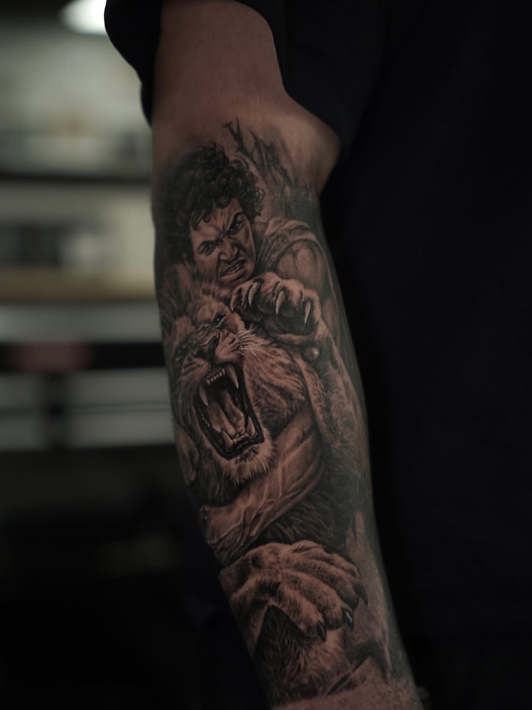 Man fighting a lion realism tattoo on the forearm by Nelson Tellez