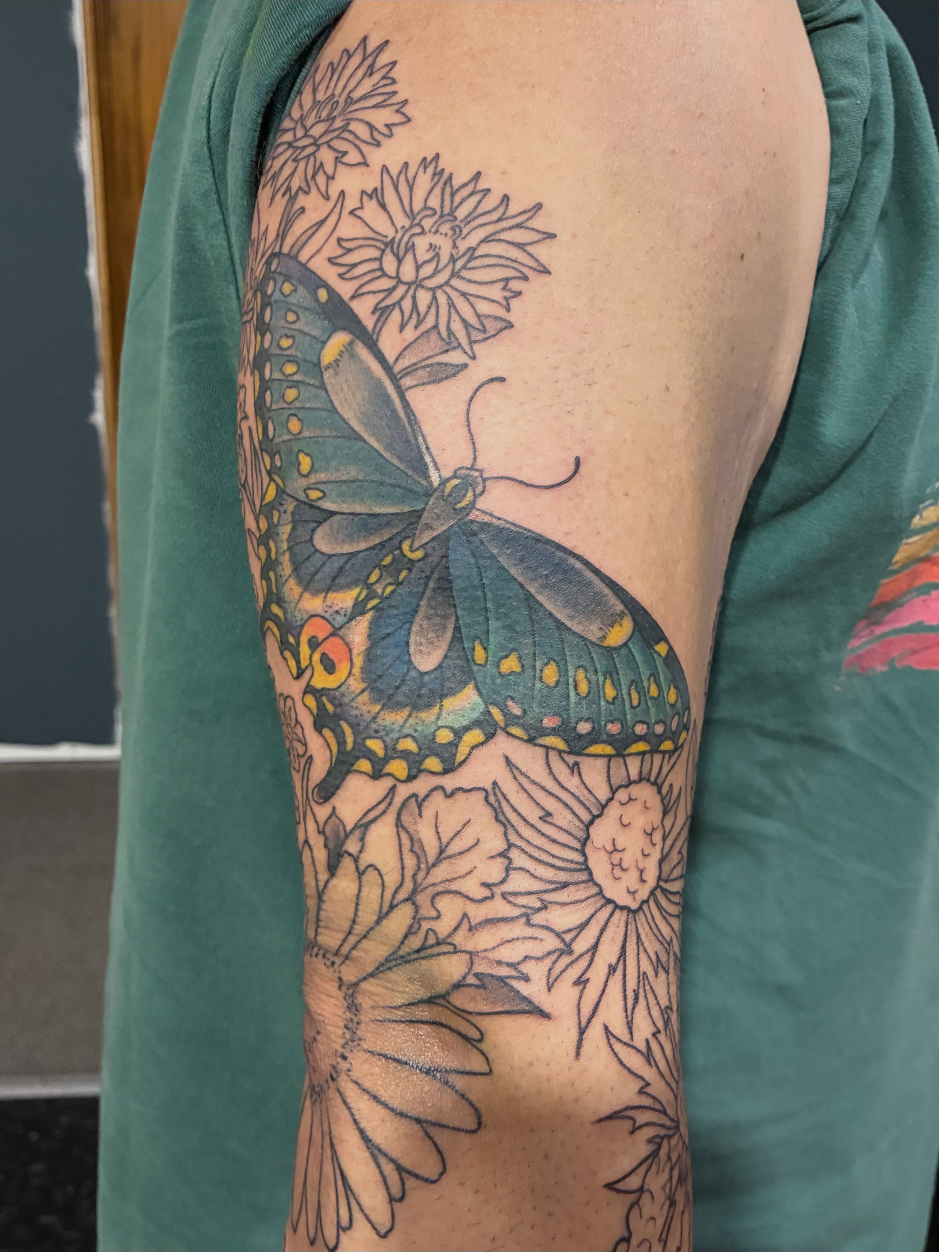 Butterfly and flowers new school tattoo on the forearm by Natalie Spuhler