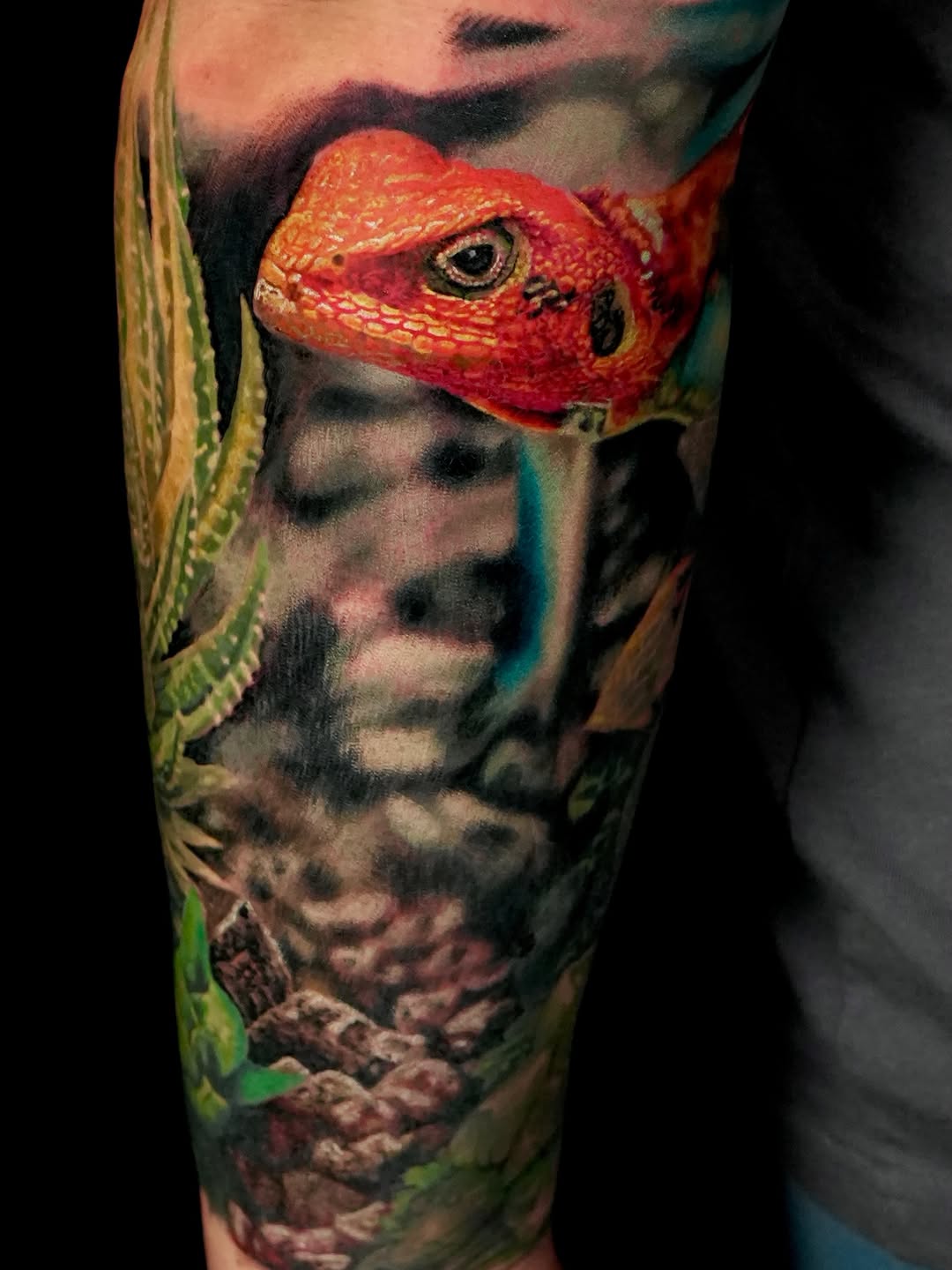 Red lizard and plants surrealism tattoo on the forearm by B R A D C H A R L e S