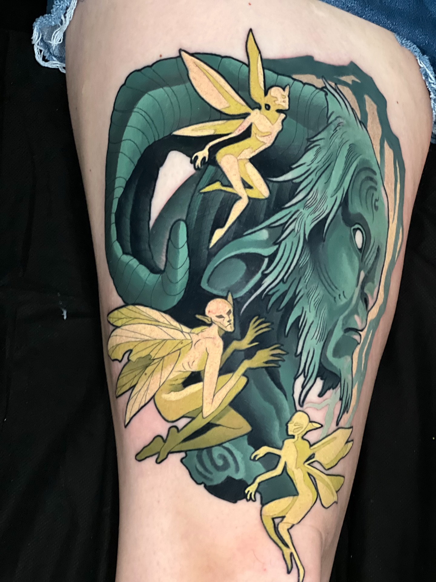 Fairies and dragon illustrative tattoo on the thigh by Tyler Wright