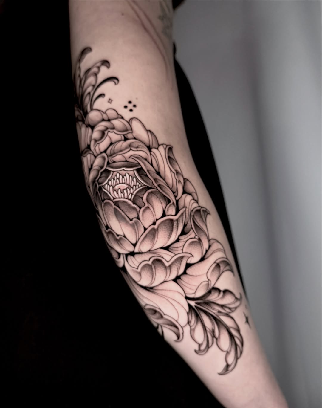 Peony flower fine line tattoo on the forearm by Kathryn Semus
