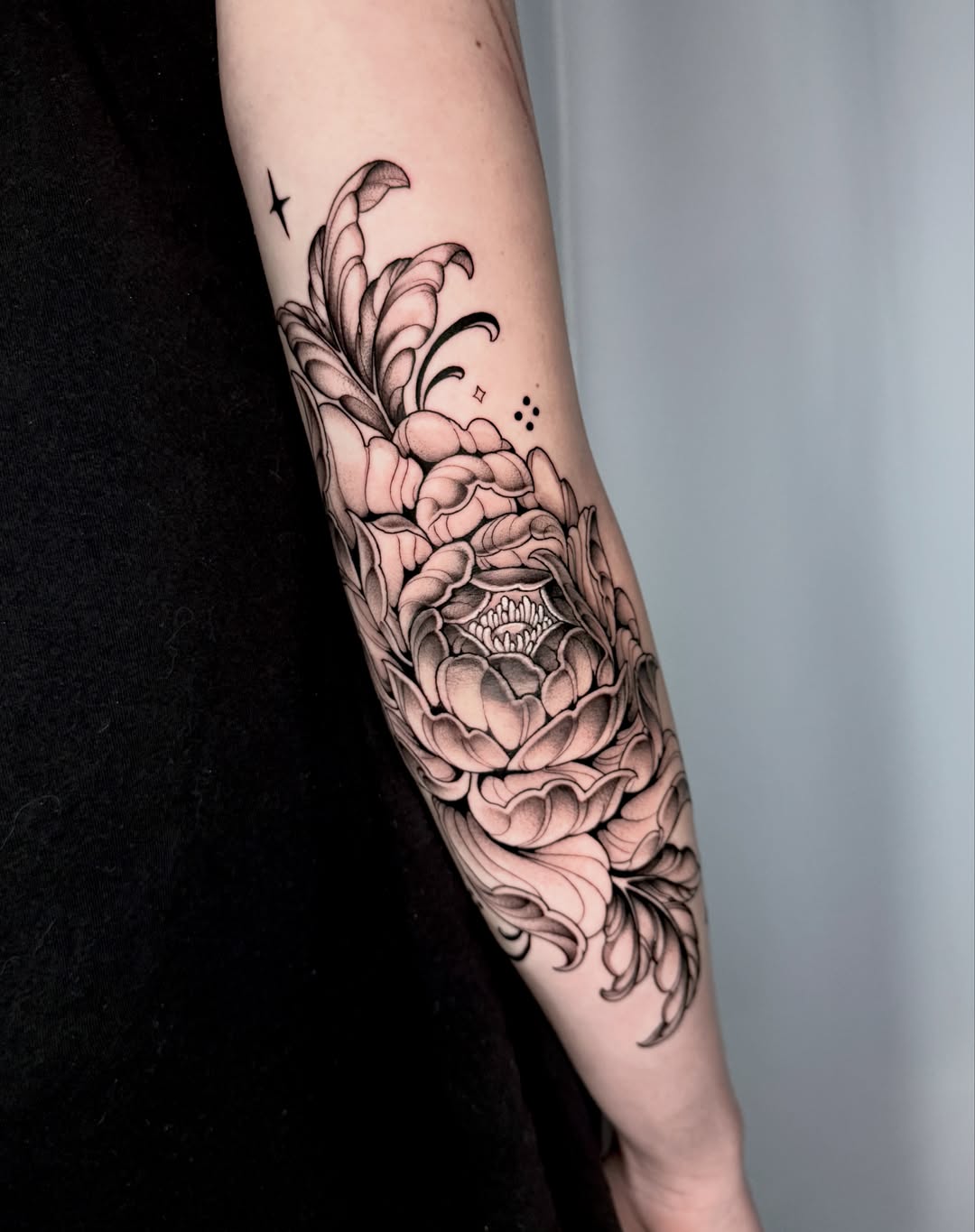 Peony flower fine line tattoo on the forearm by Kathryn Semus