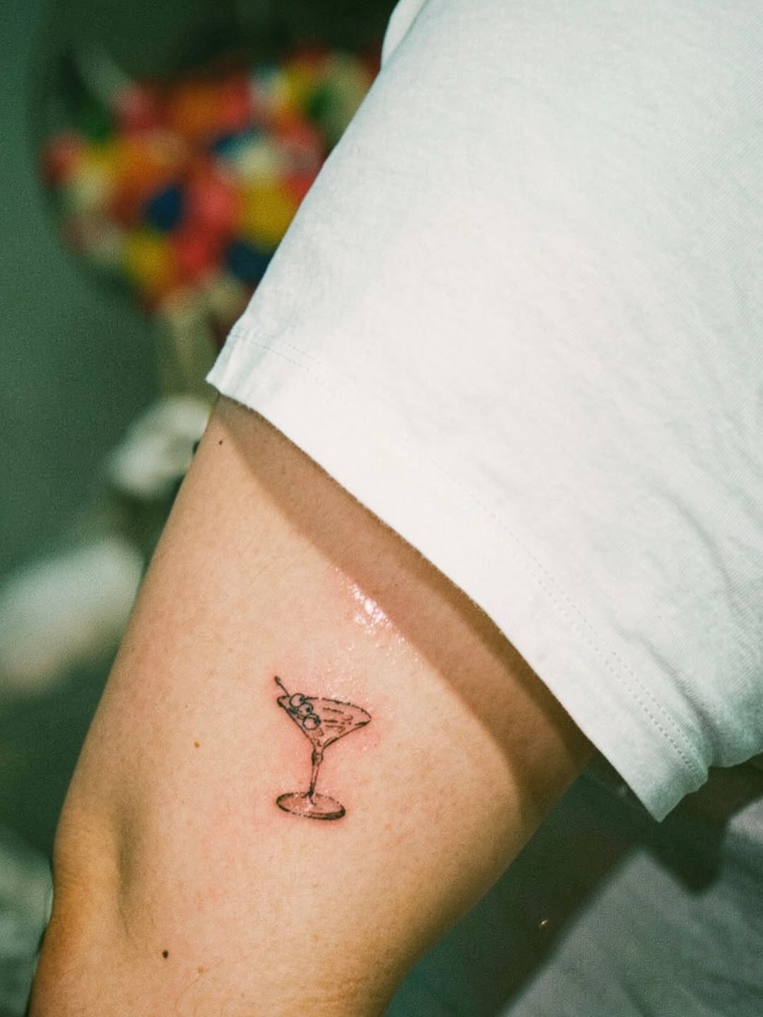 Martini glass with olives minimalist tattoo on the forearm by @elijahtats