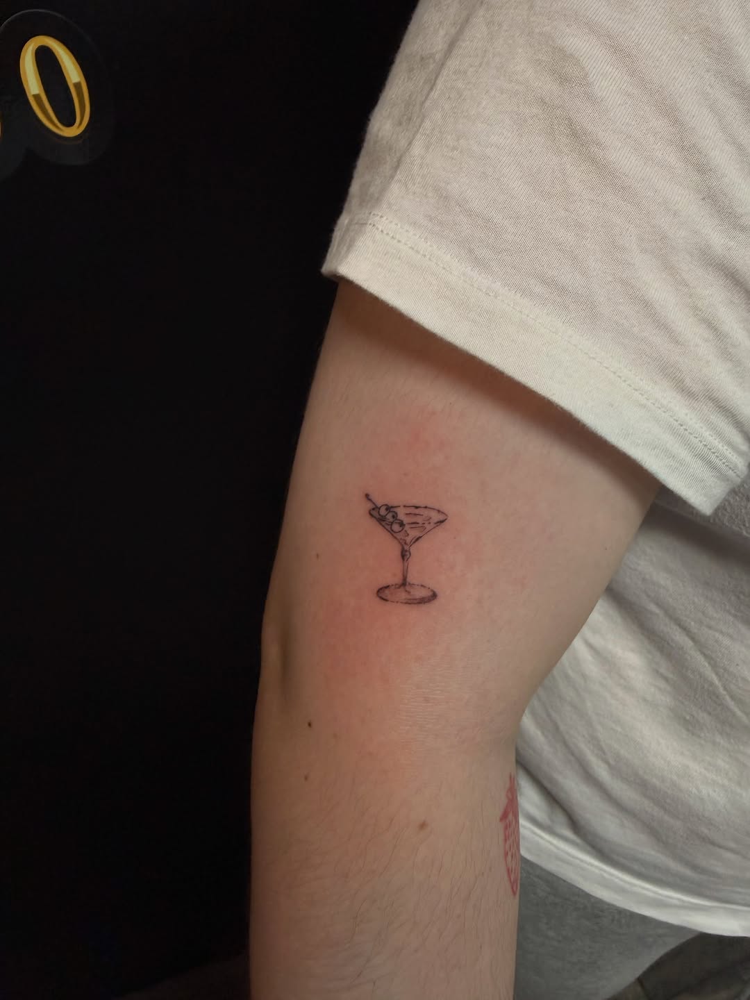 Martini glass with olives minimalist tattoo on the forearm by @elijahtats