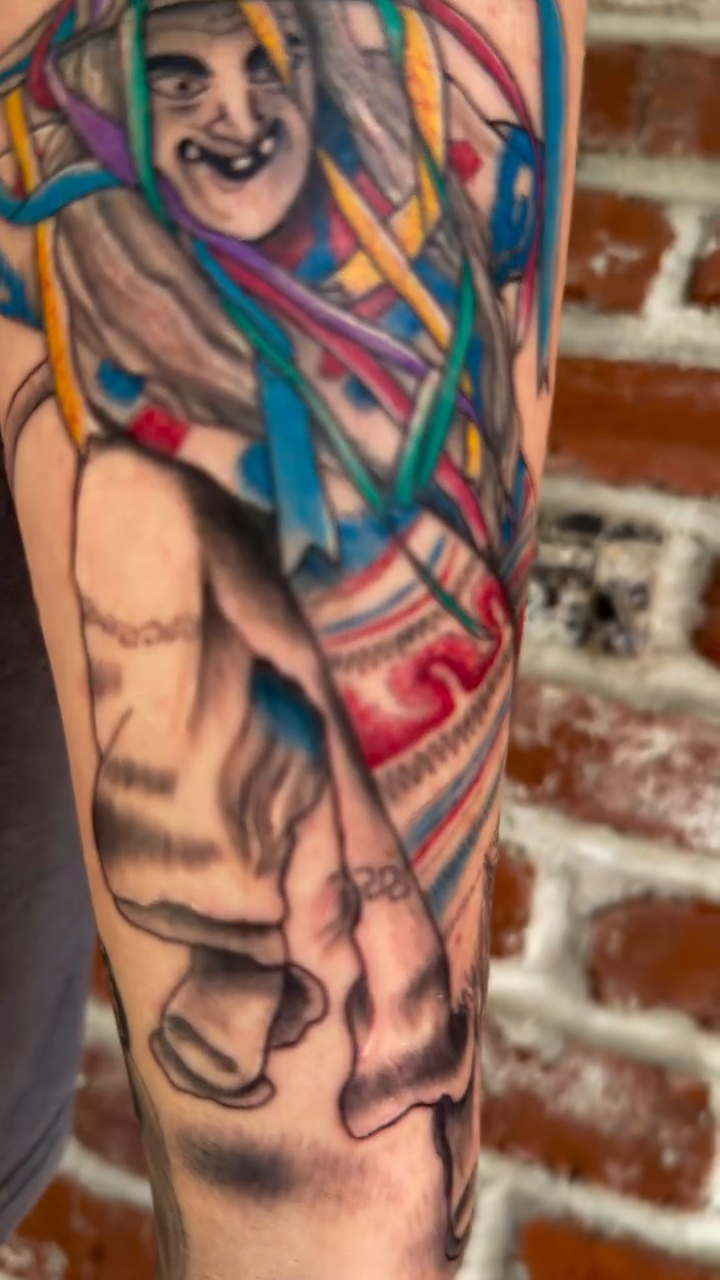 A witch with colorful ribbons neo-traditional tattoo on the forearm by Charlotte (Luna), Seattle, Washington