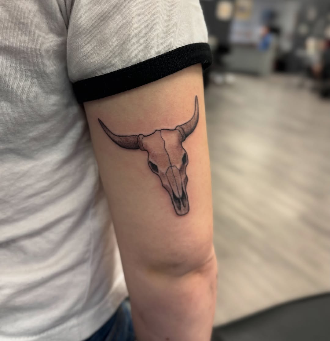 Bull skull minimalist tattoo on the forearm by Israel Jacob Woehler