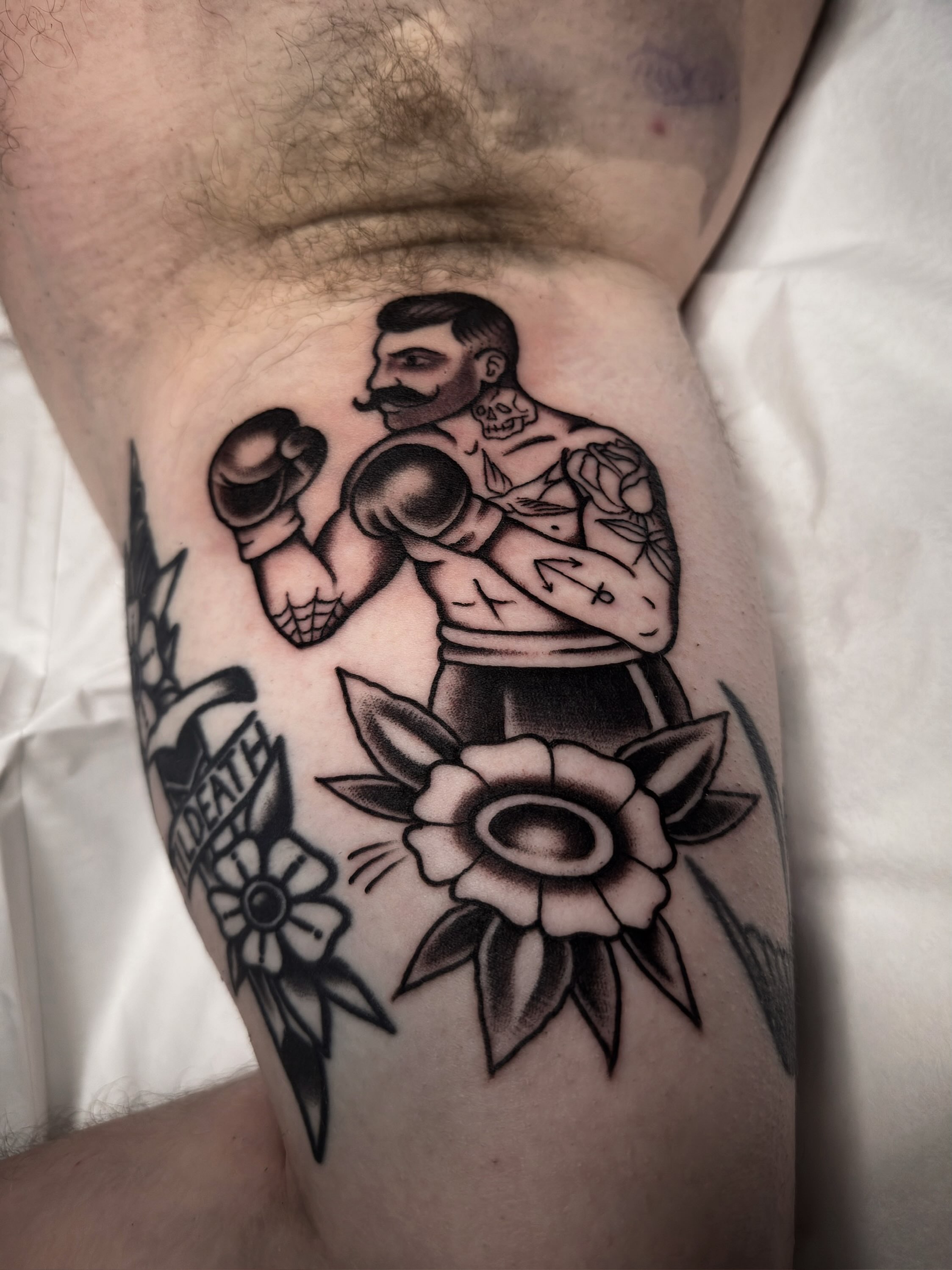Boxing man with flowers American traditional tattoo on the forearm by Trav, Bayville, New Jersey