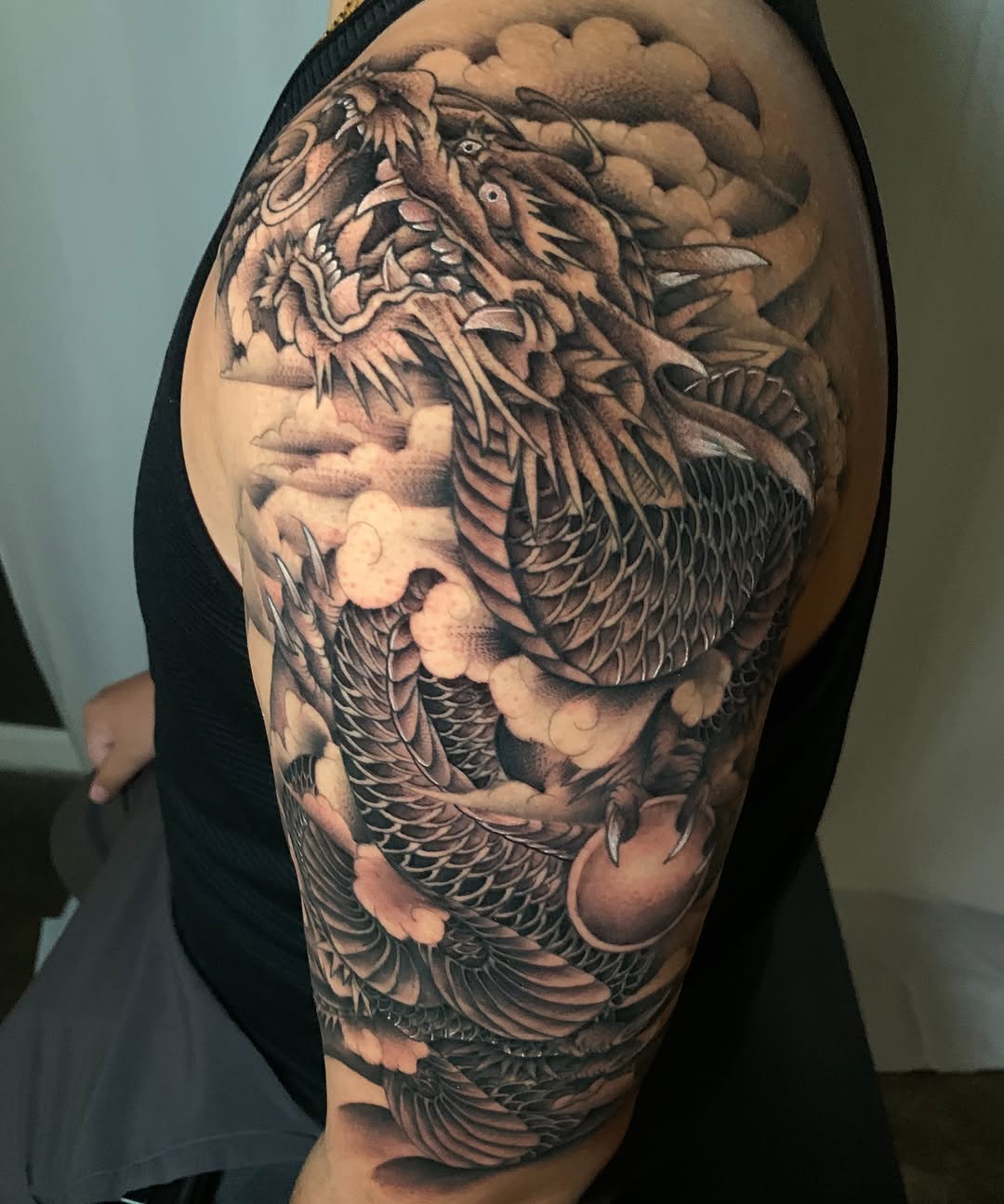 Dragon with clouds Japanese tattoo on the shoulder by Cuda