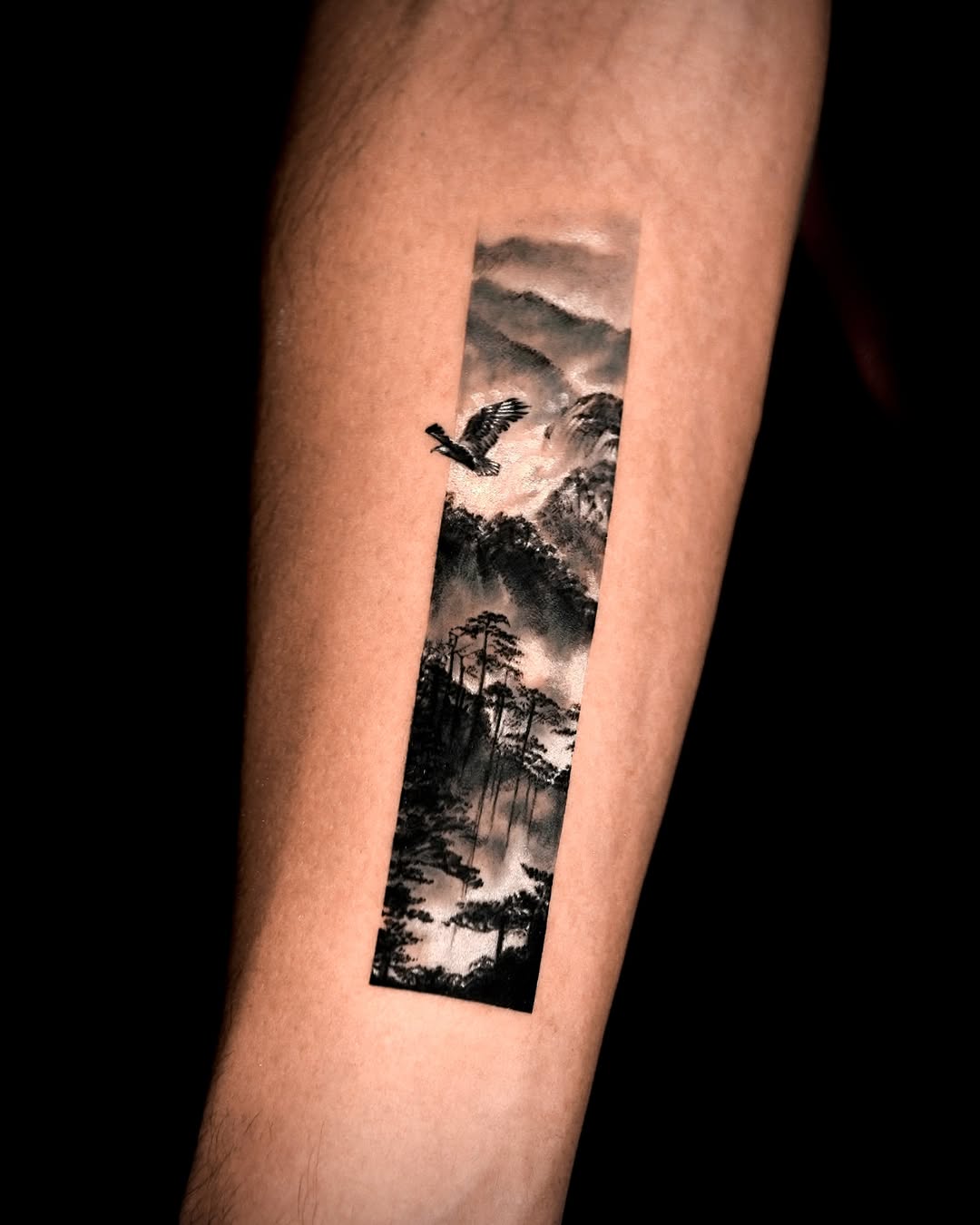 Mountain landscape with eagle fine line tattoo on the forearm by Rizn