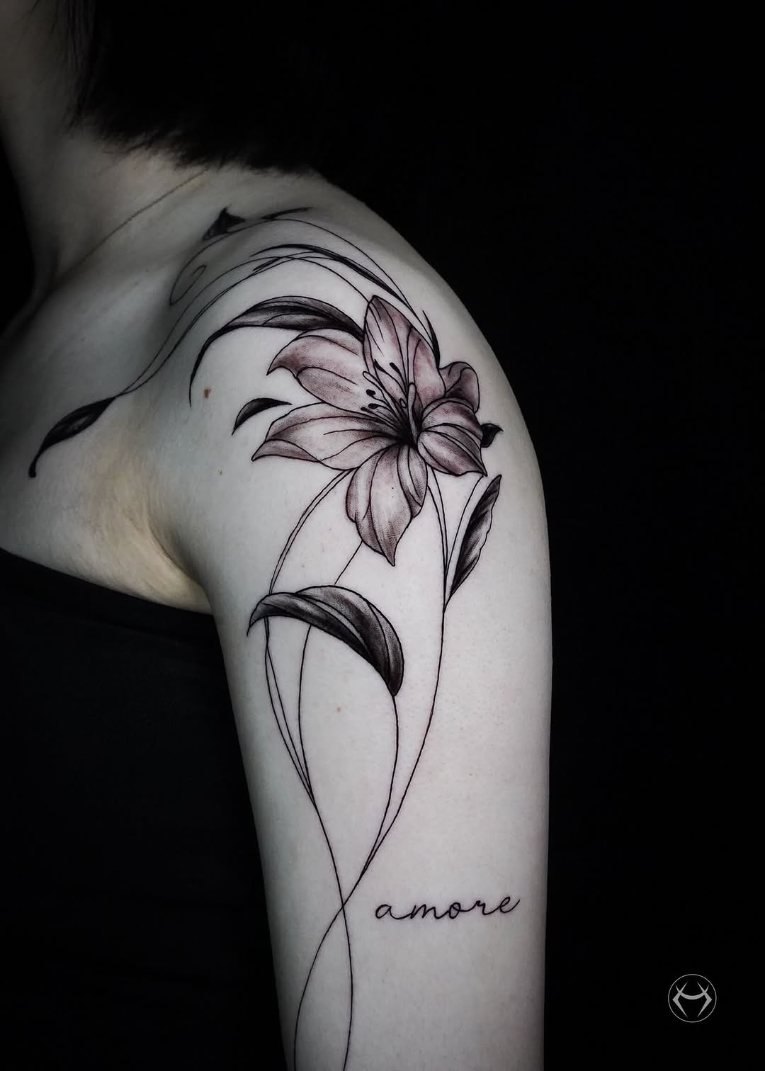 Lily and script lettering fine line tattoo on the shoulder by Mali Sarsılmaz, Nicosia, Cyprus