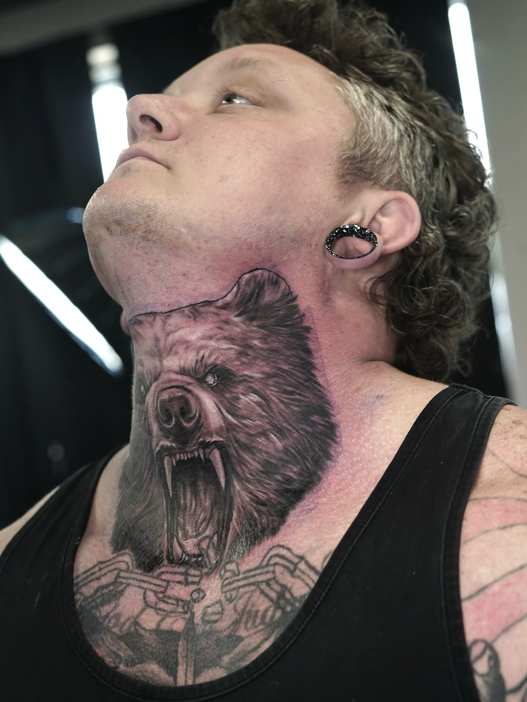 Bear head realism tattoo on the neck by Nelson Tellez
