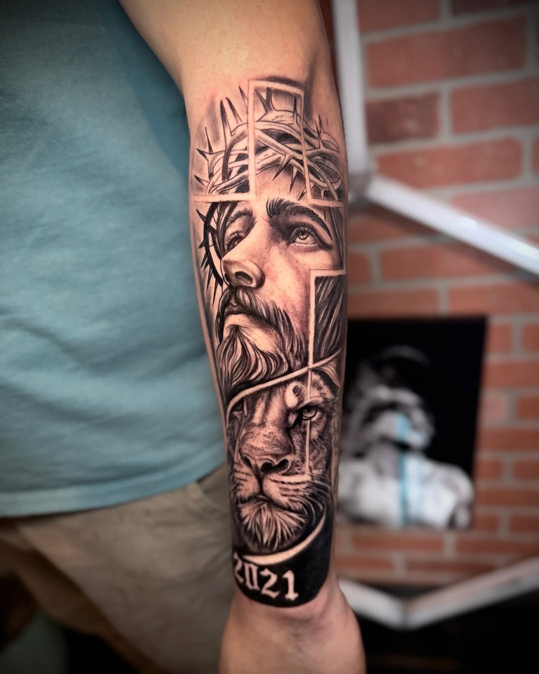 Jesus and lion Chicano tattoo on the forearm by Andres Calvo🇺🇸🇨🇴